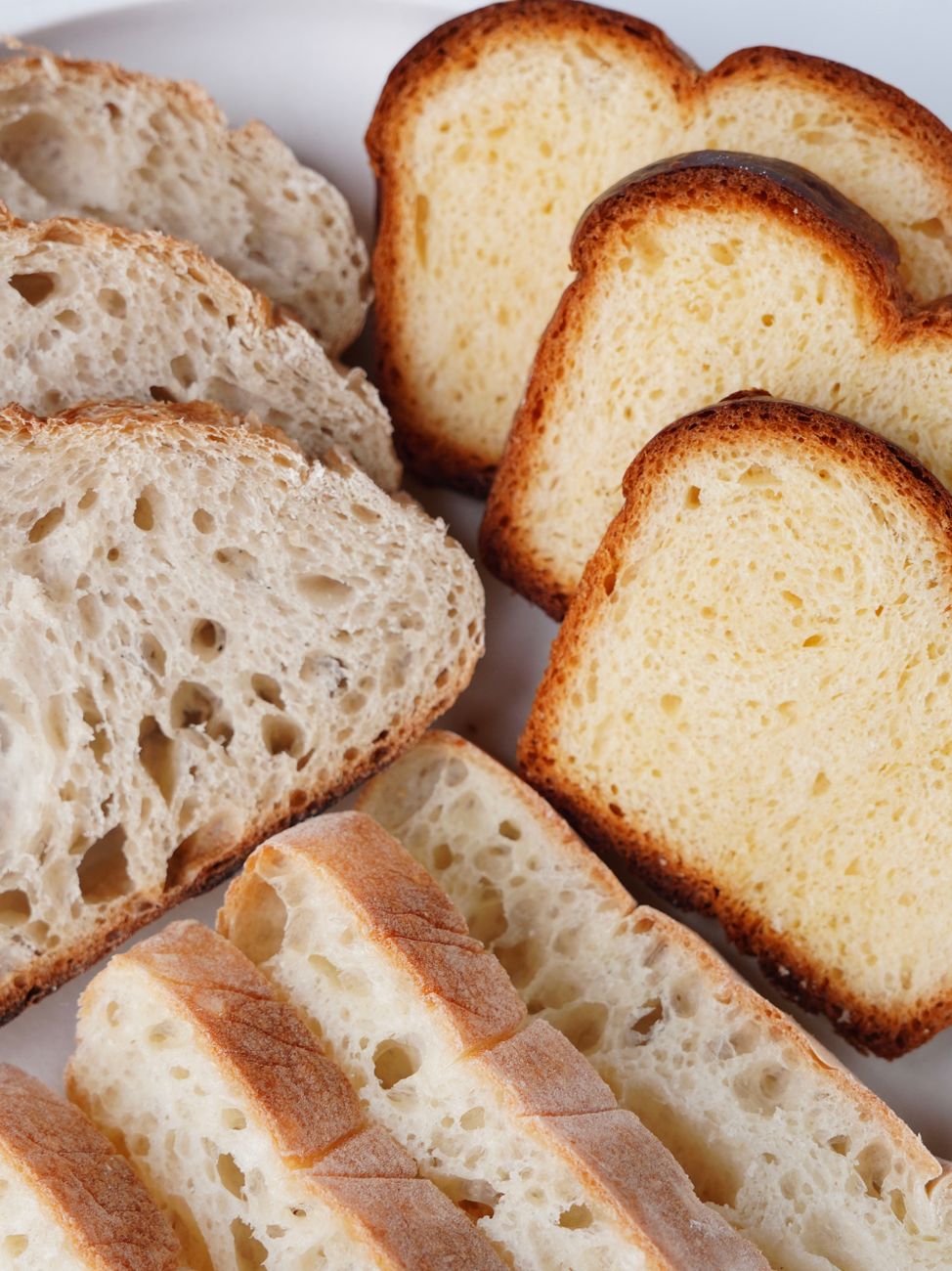 Close-up of assorted fresh bread slices, highlighting textures and variety