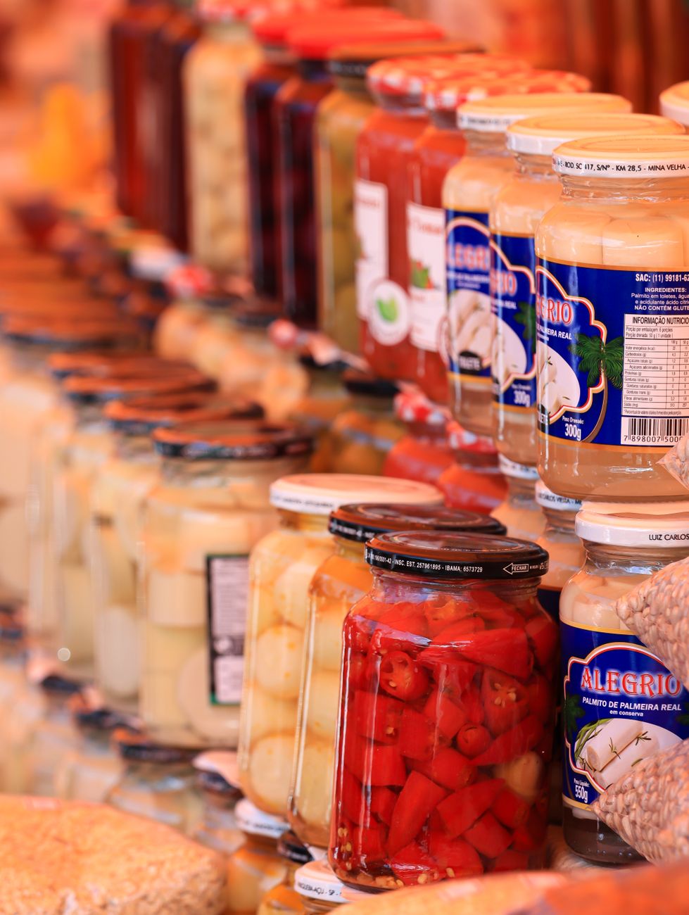 A market display of assorted jars filled with preserved condiments