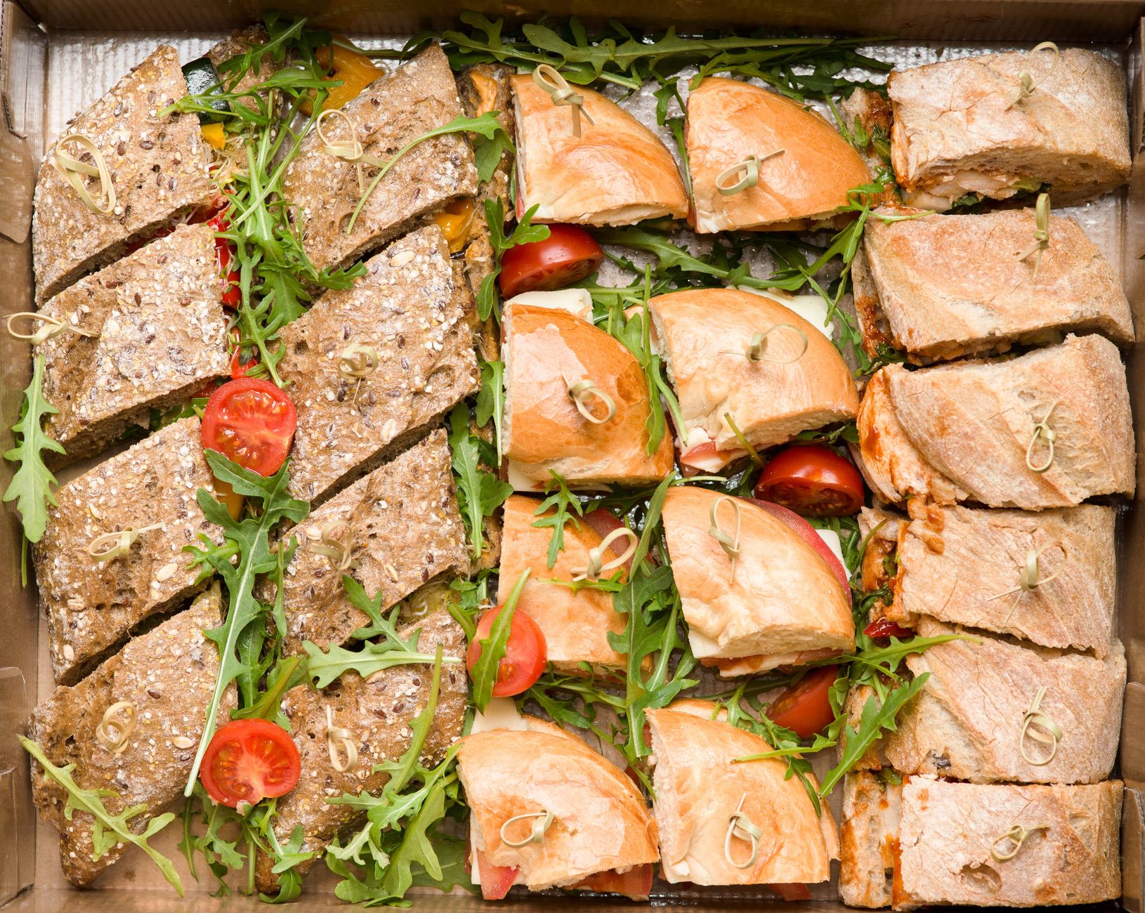 An assorted sandwich platter with fresh ingredients on display