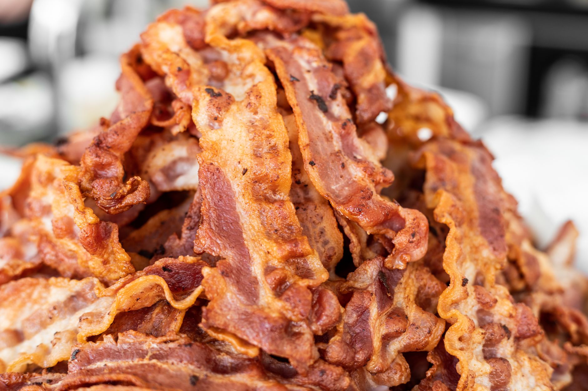 A close-up photograph of crispy cooked bacon strips
