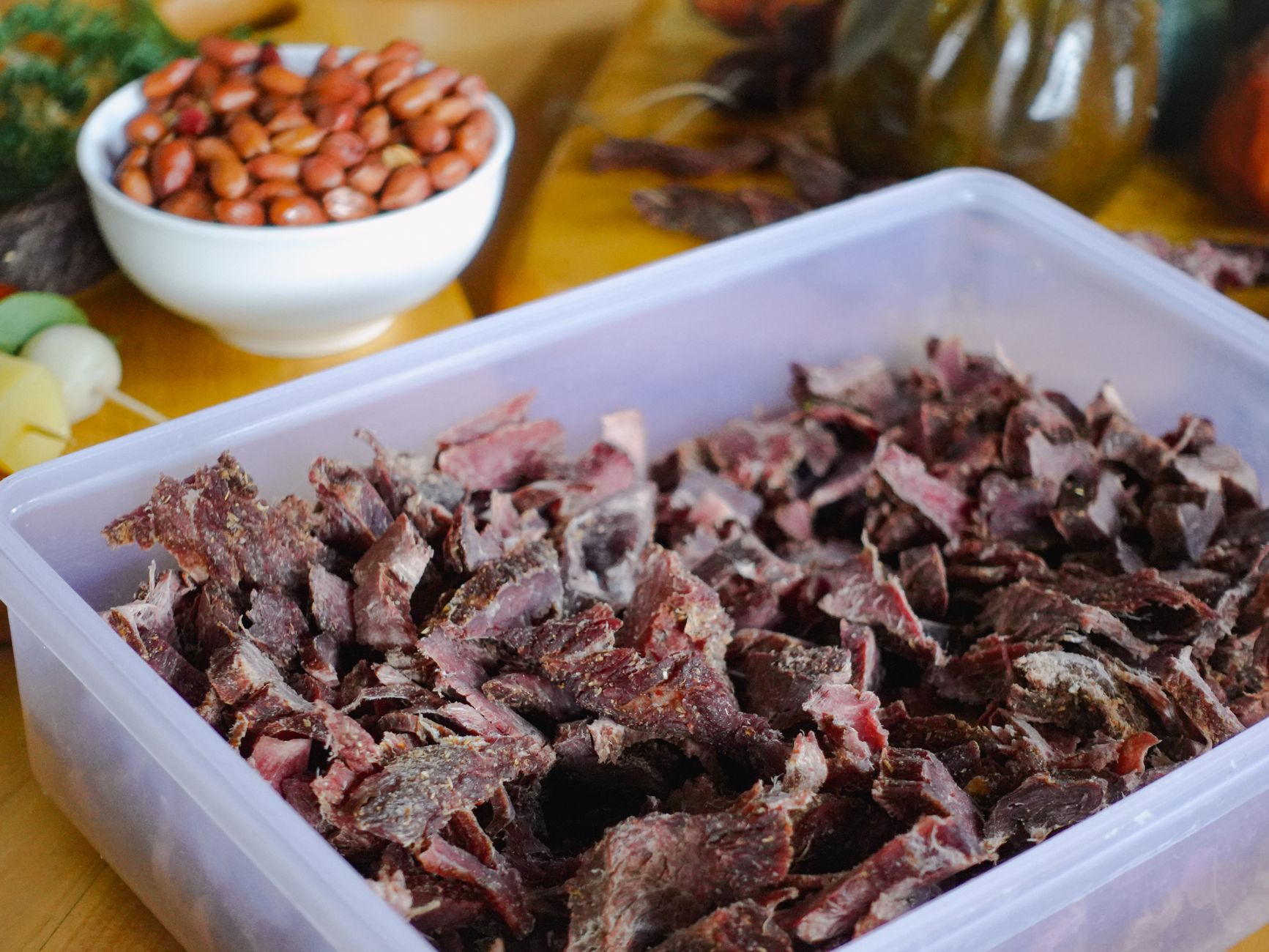 A delicious biltong dried meat snack served with a side of peanuts