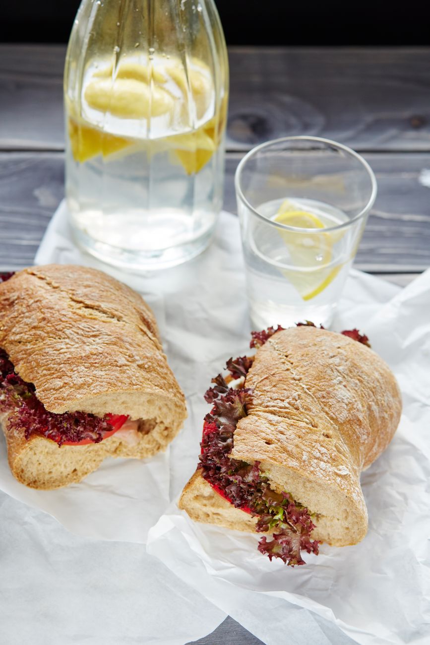A vibrant BLT sandwich paired with refreshing lemon water