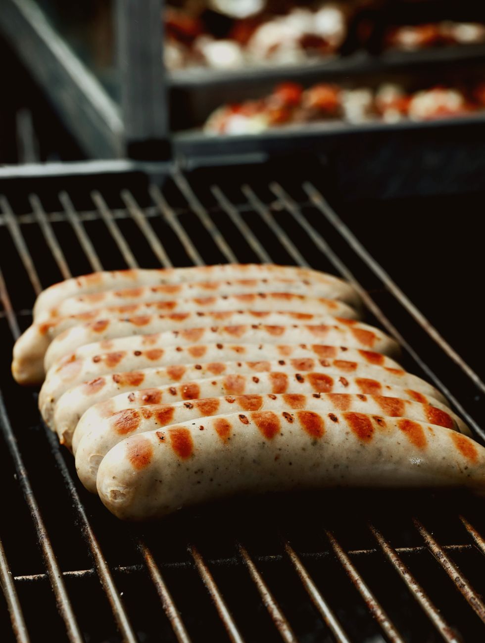 Delicious bratwurst sausages grilling on a BBQ, ready to serve