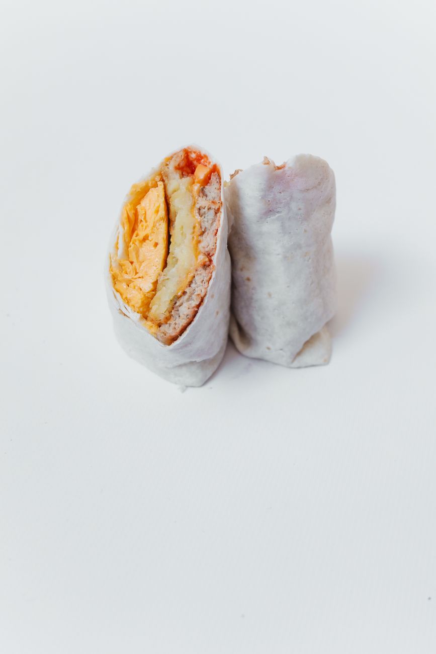 A breakfast burrito filled with cheese and scrambled eggs