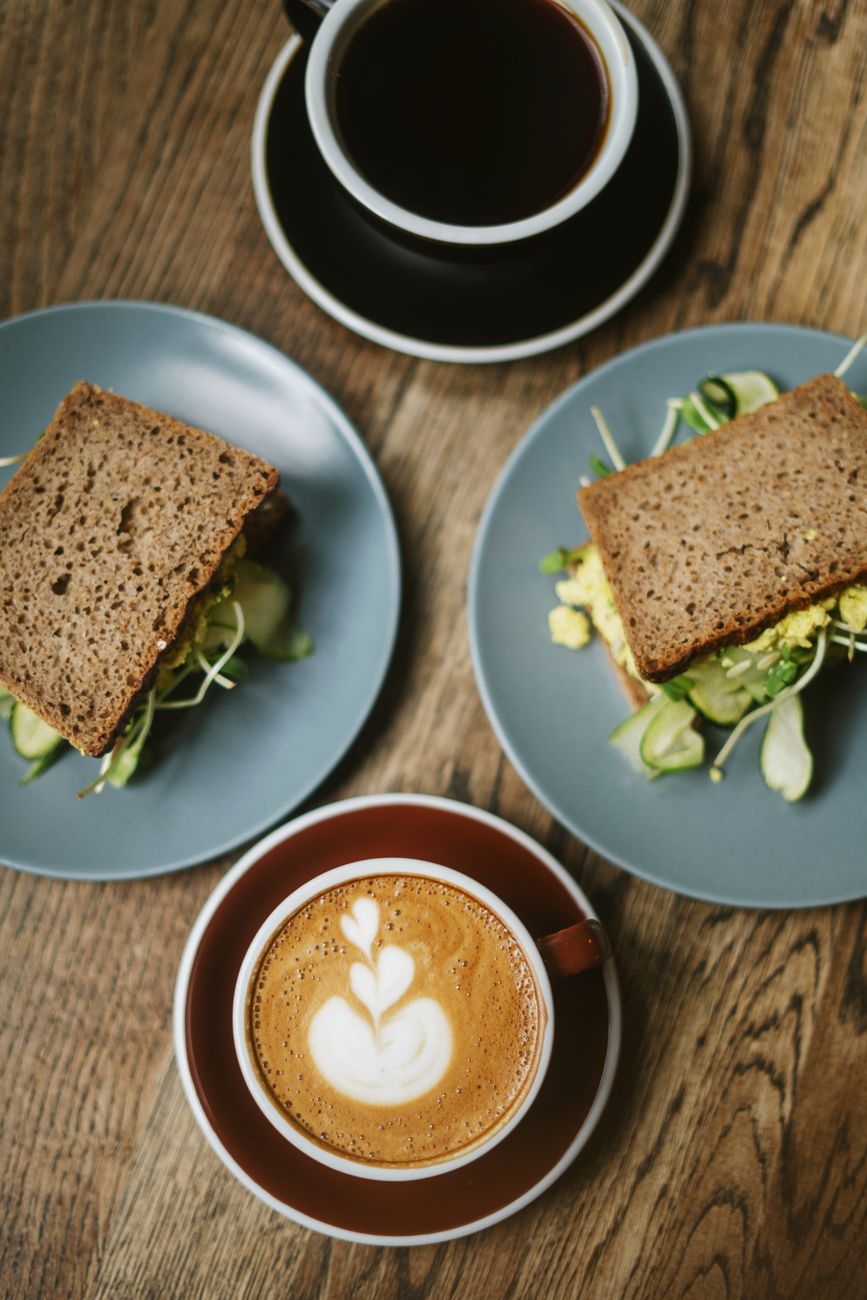 A breakfast spread with coffee and freshly made sandwiches