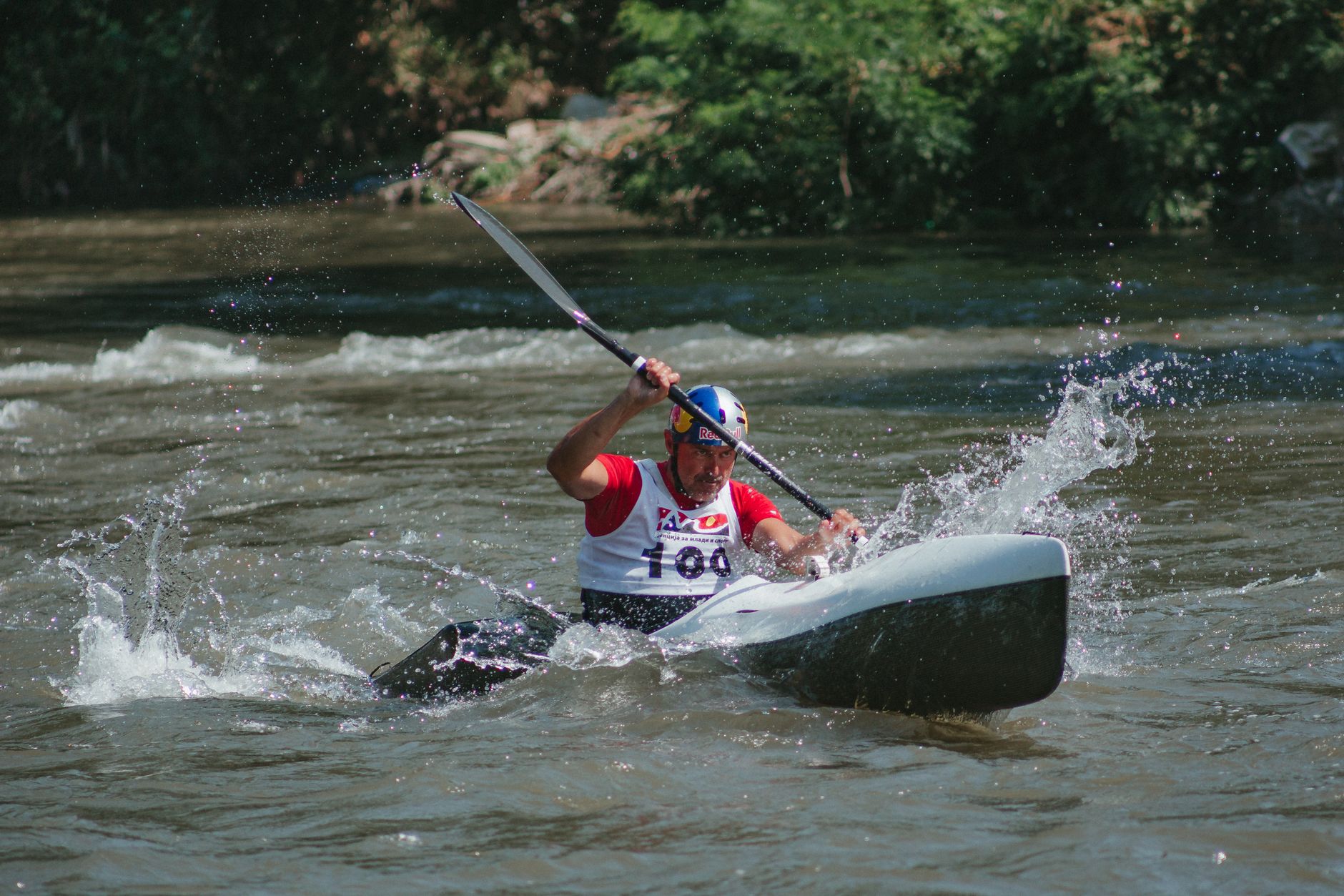 An intense moment of a canoe race with a sportsman navigating rapids