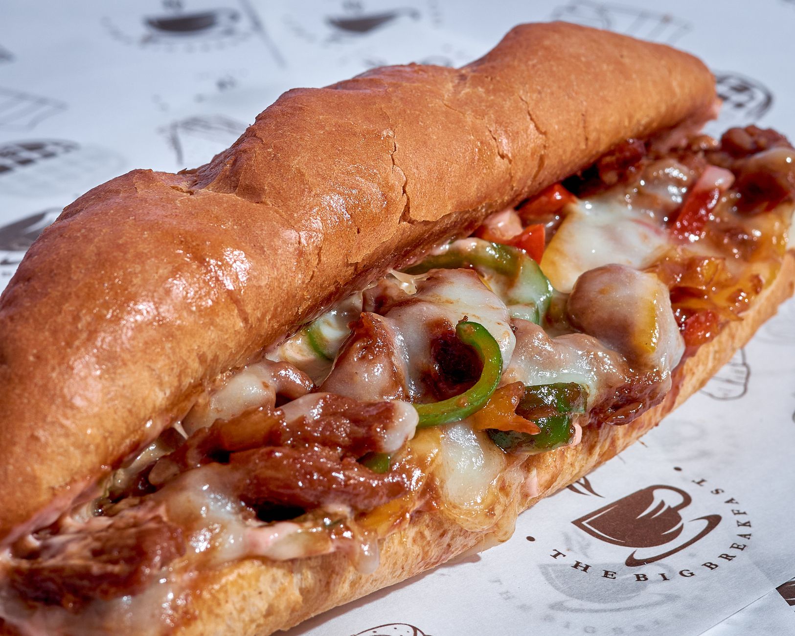 A mouthwatering cheesesteak sub with melted cheese and onions