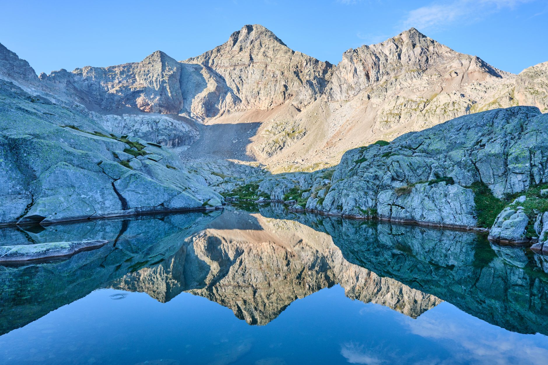 A stunning mountain scene with a clear lake reflecting rugged peaks