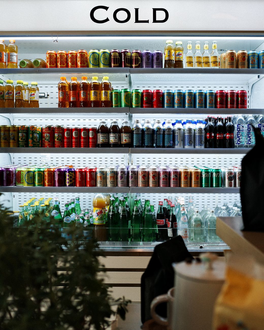 A vibrant array of drinks showcased in a cold beverage refrigerator