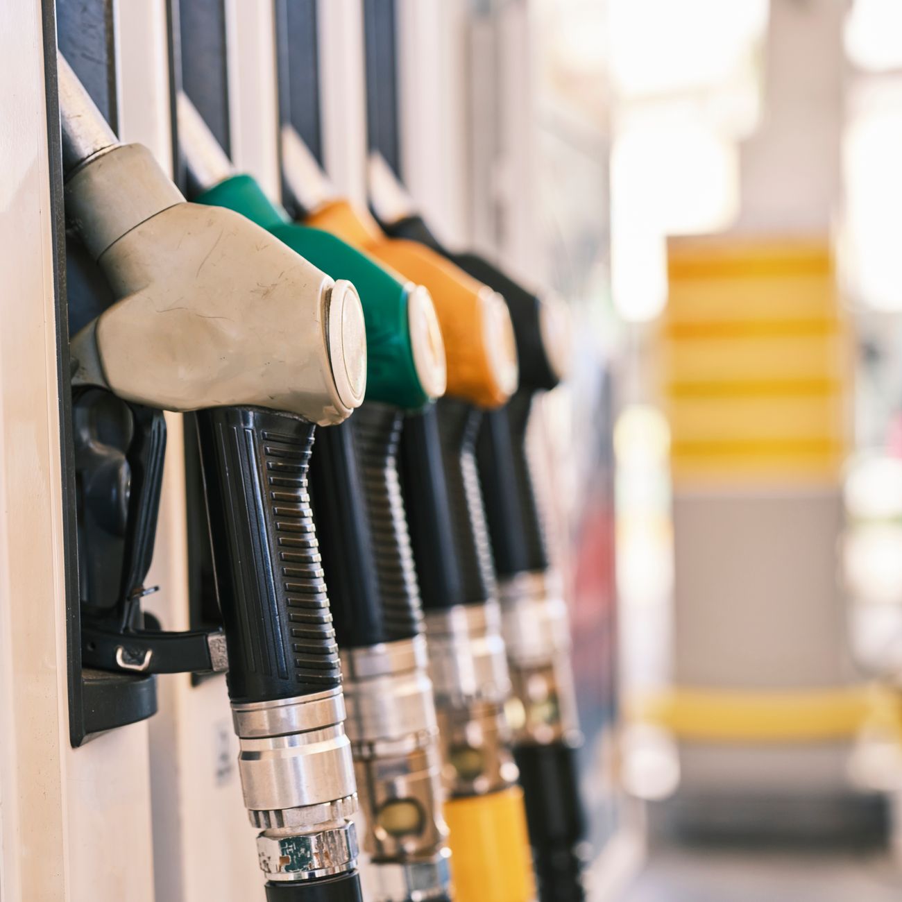 Close-up shot of colorful gas pump nozzles at a fuel station