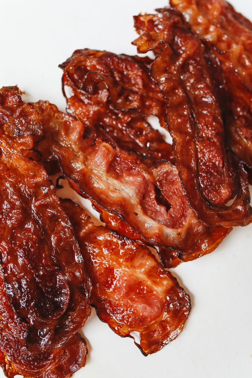 A close-up photo of crispy cooked bacon strips