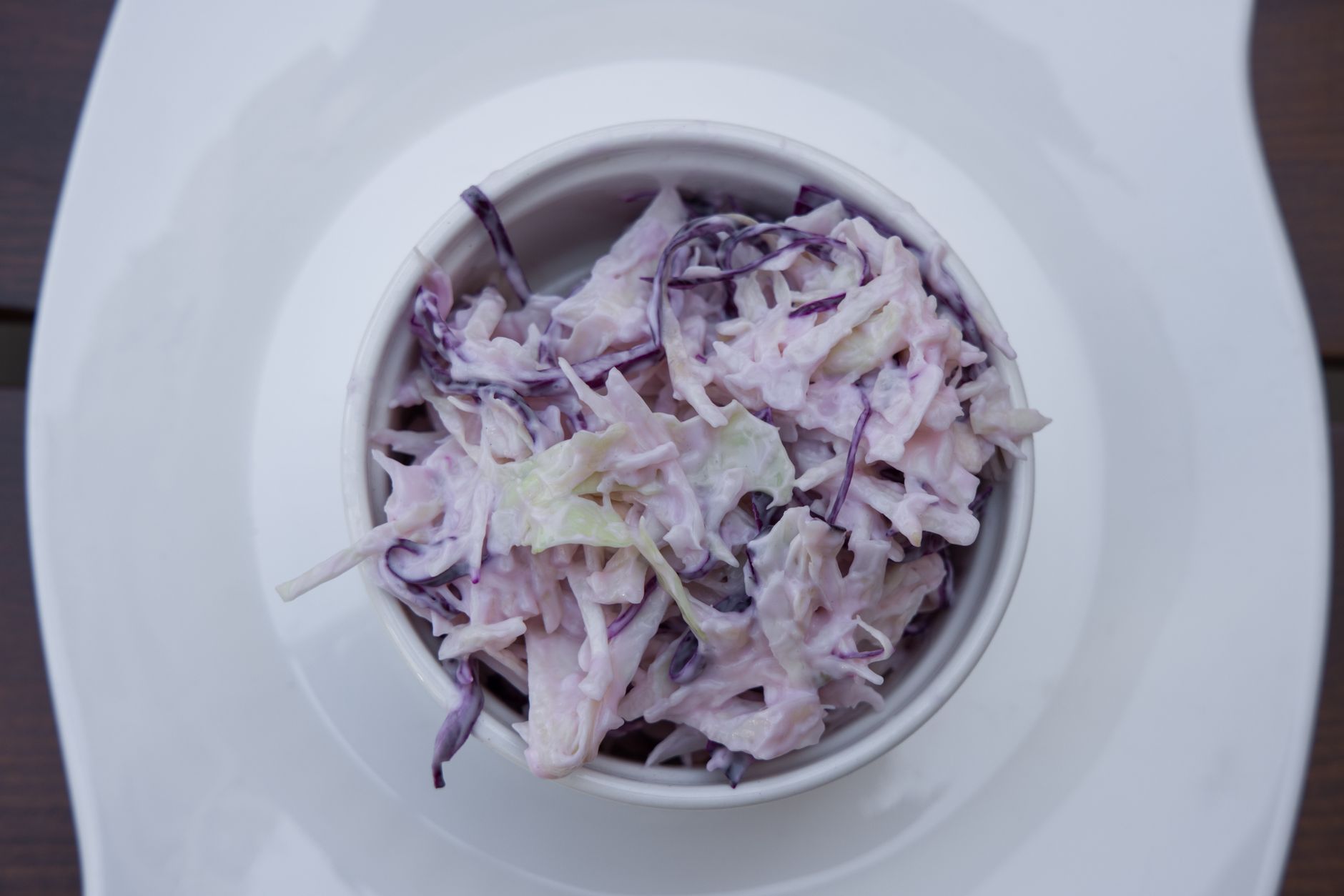 Delicious creamy coleslaw made with red cabbage in a white bowl