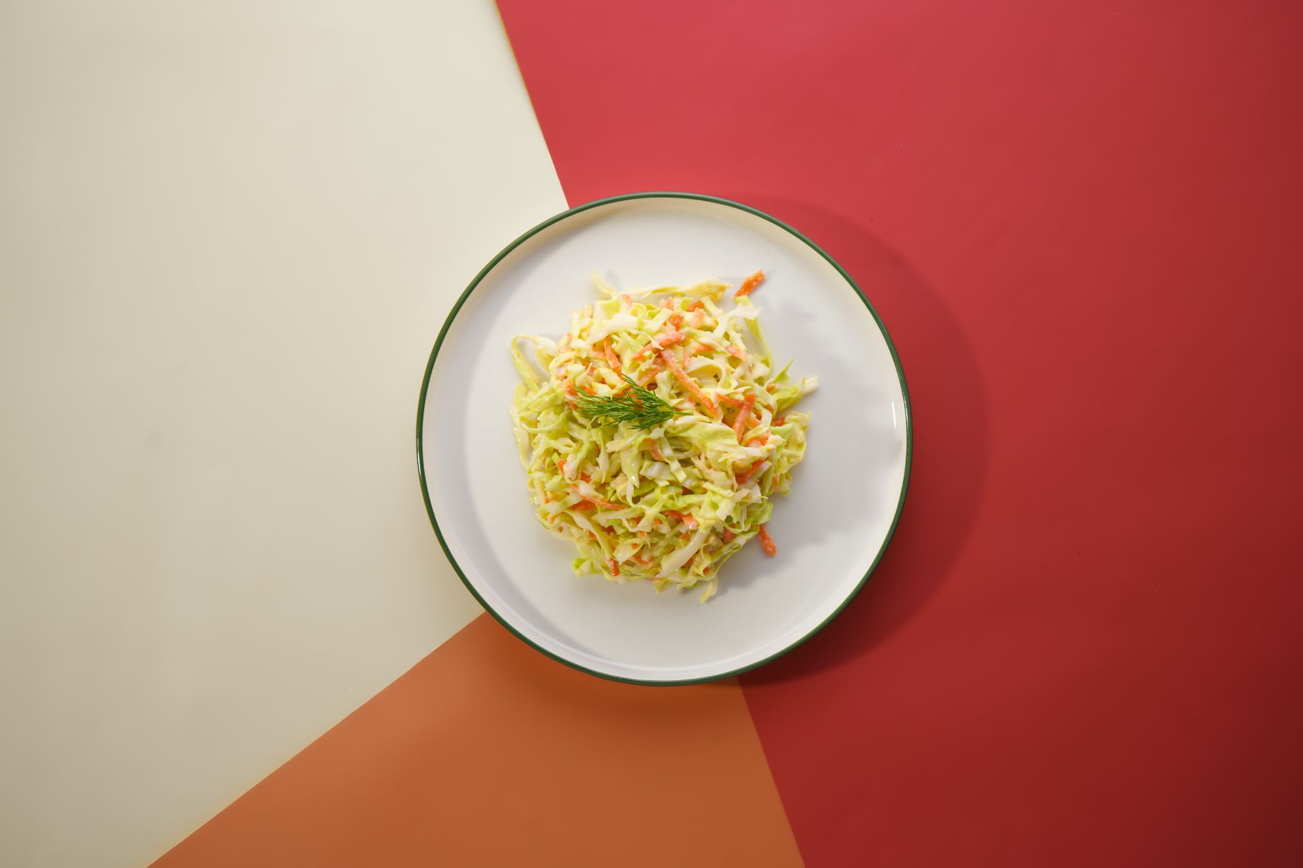 Crisp coleslaw served on a vibrant geometric backdrop