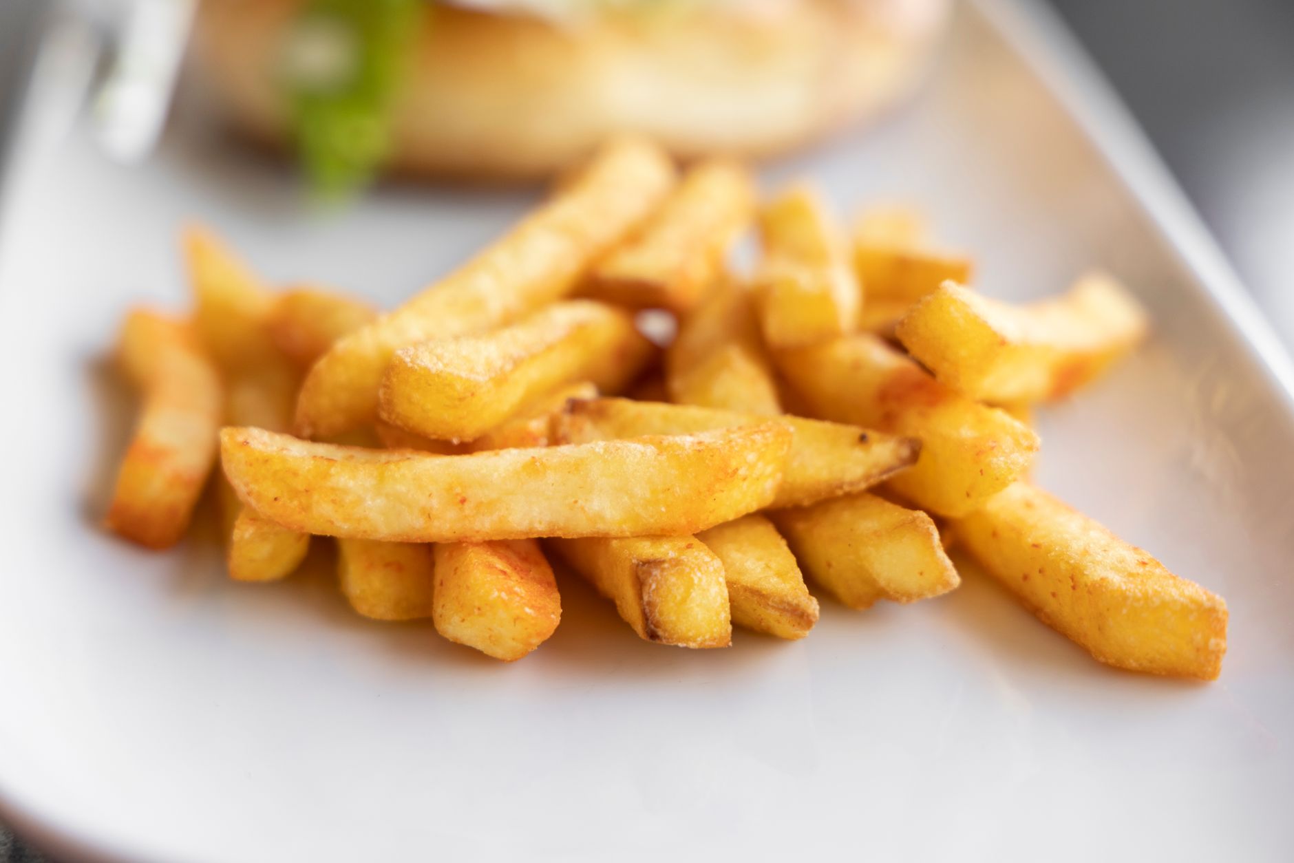 Close-up of crispy golden french fries served on a plate