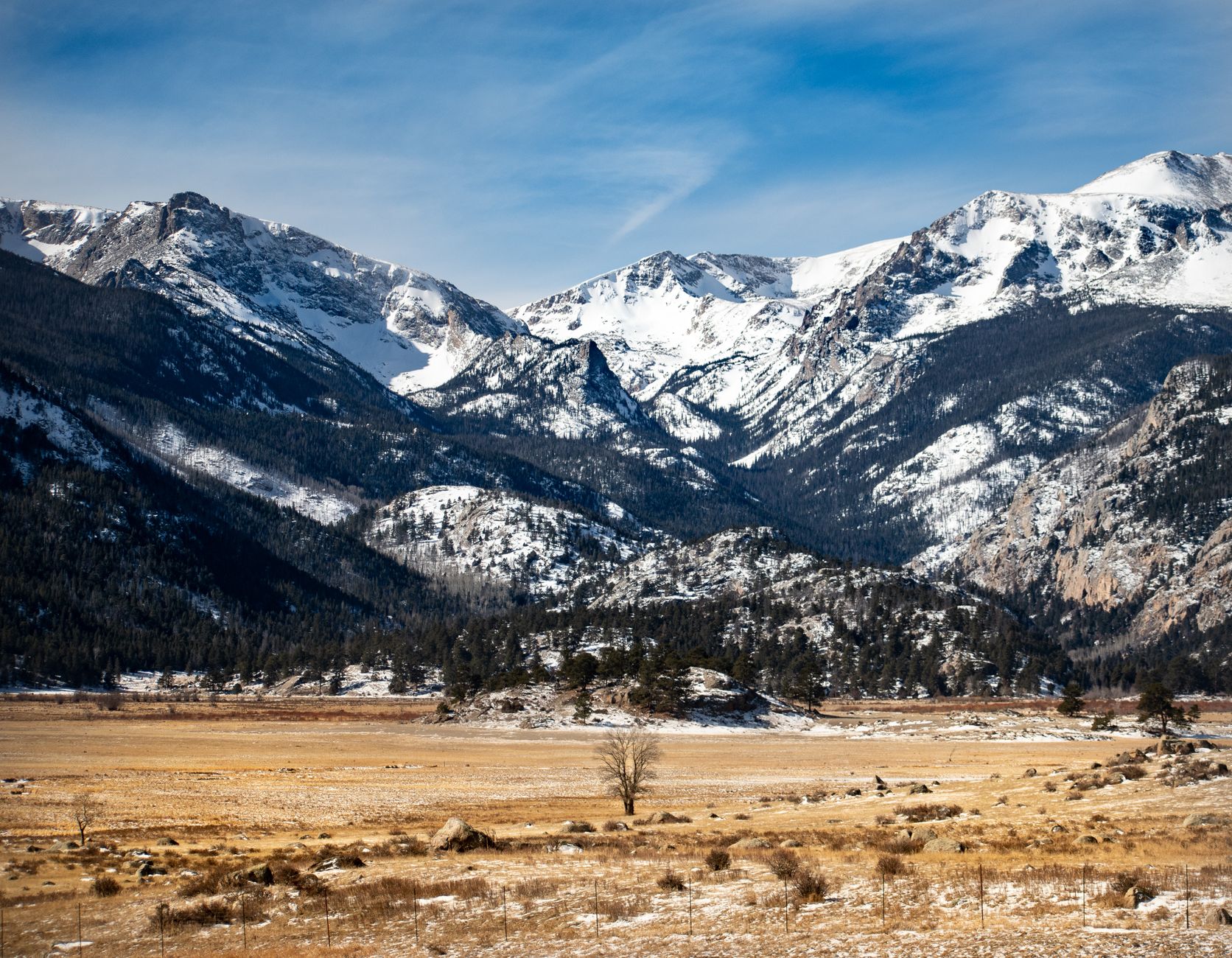 Expansive view of the Rocky Mountains with snow-covered peaks in Colorado