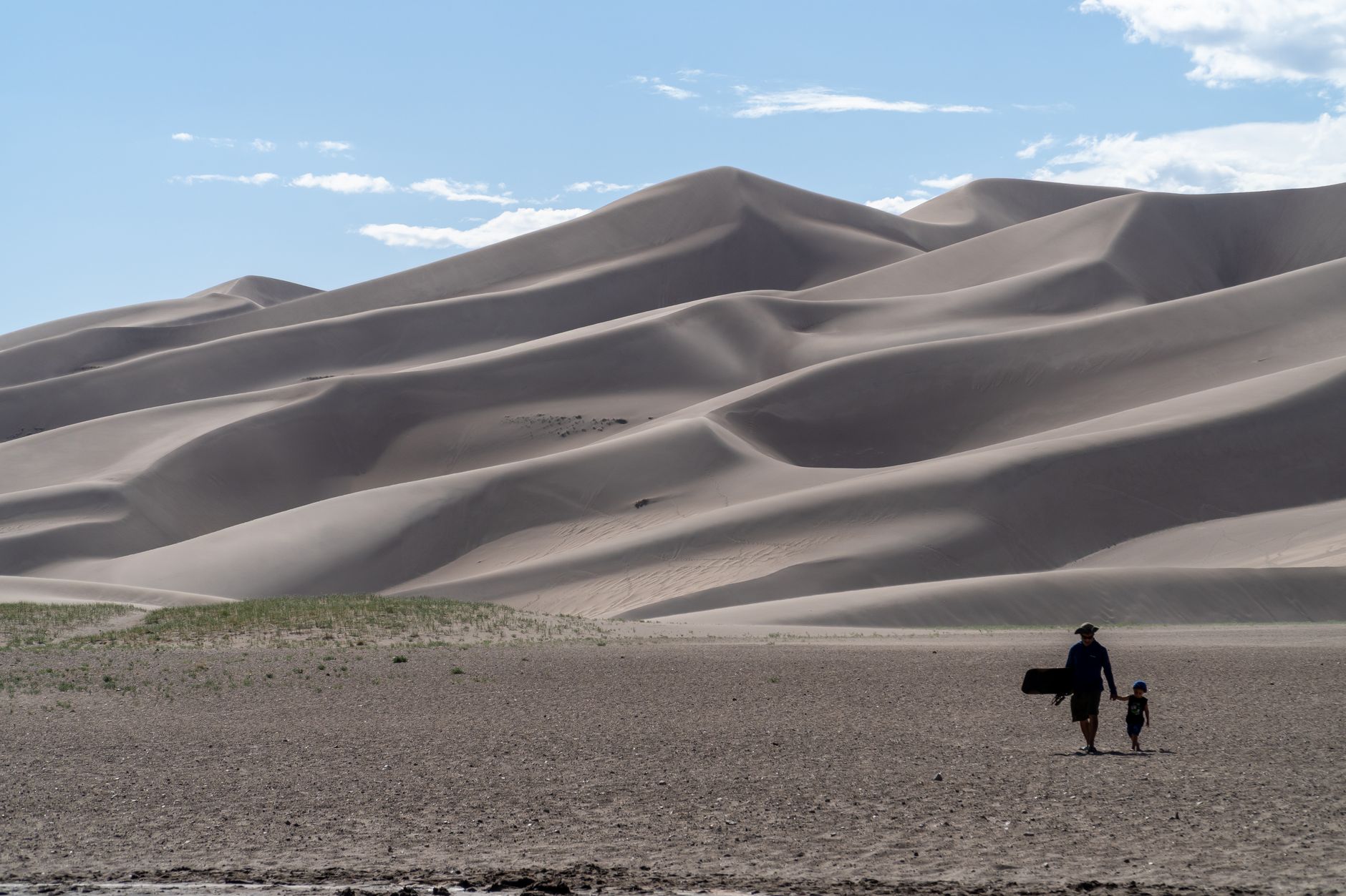 A father and son hiking together at the Great Sand Dunes in Colorado