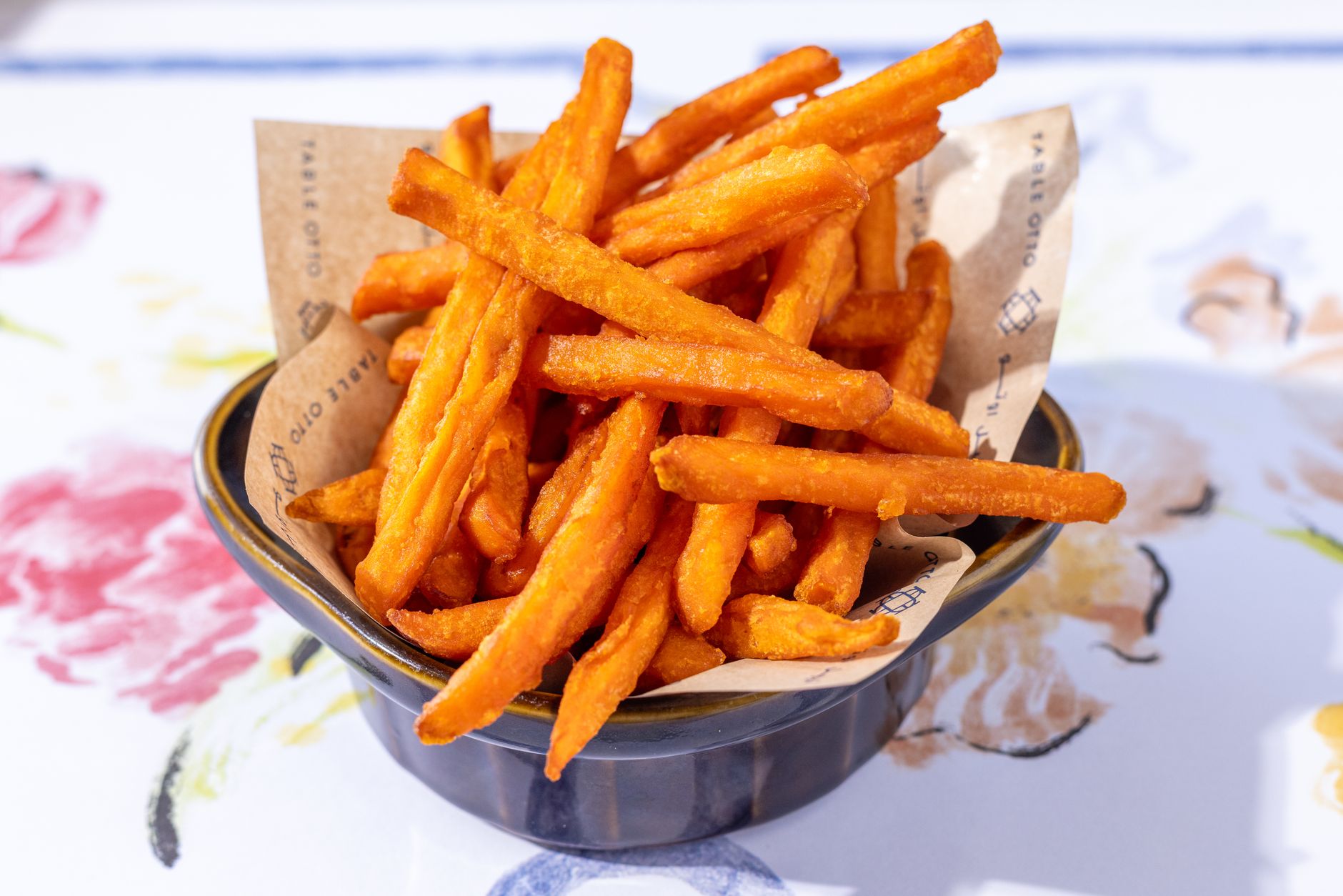 A bowl filled with fresh, crispy sweet potato fries
