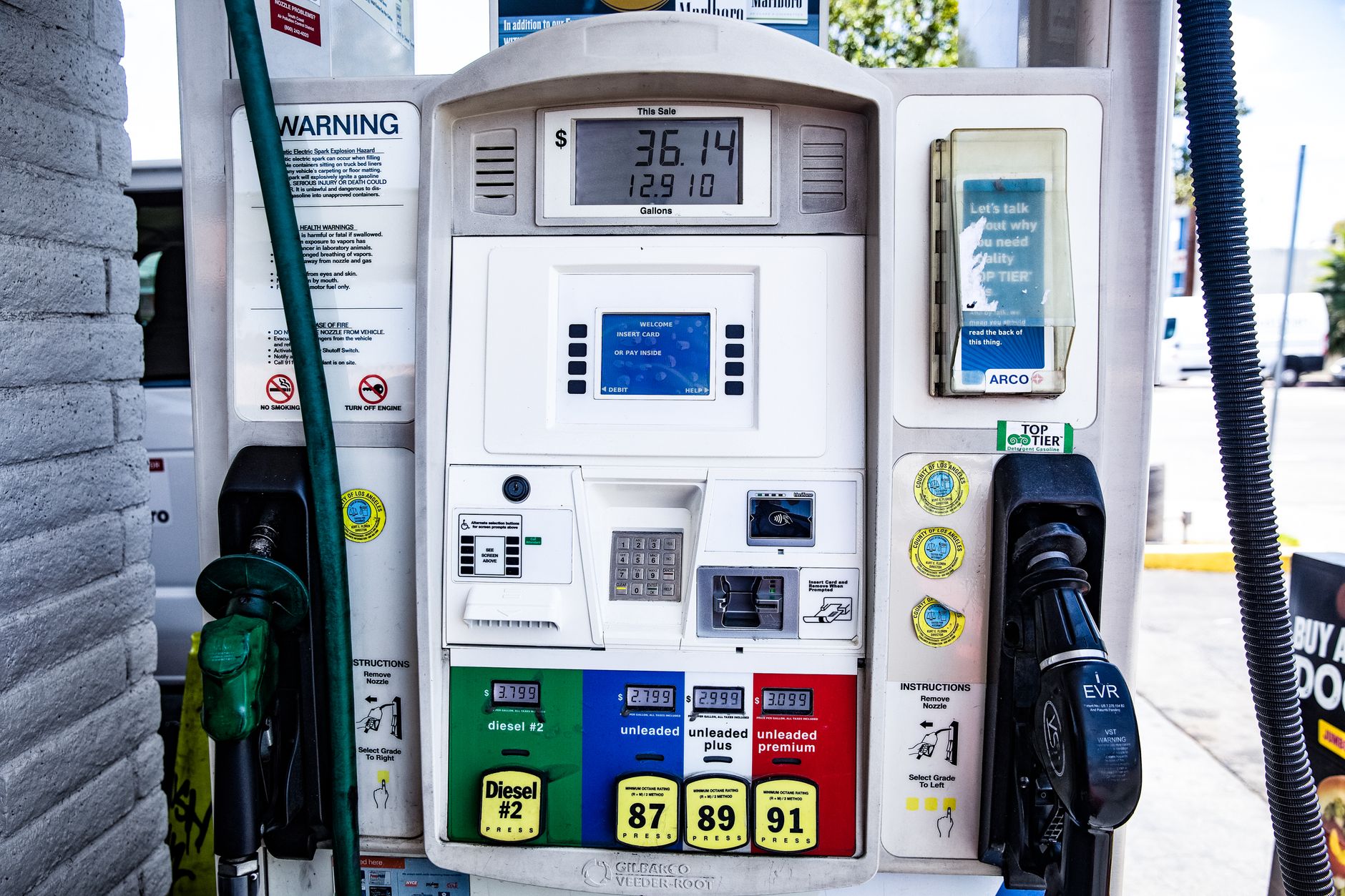 Close-up of a fuel pump showing gasoline and diesel options at a gas station