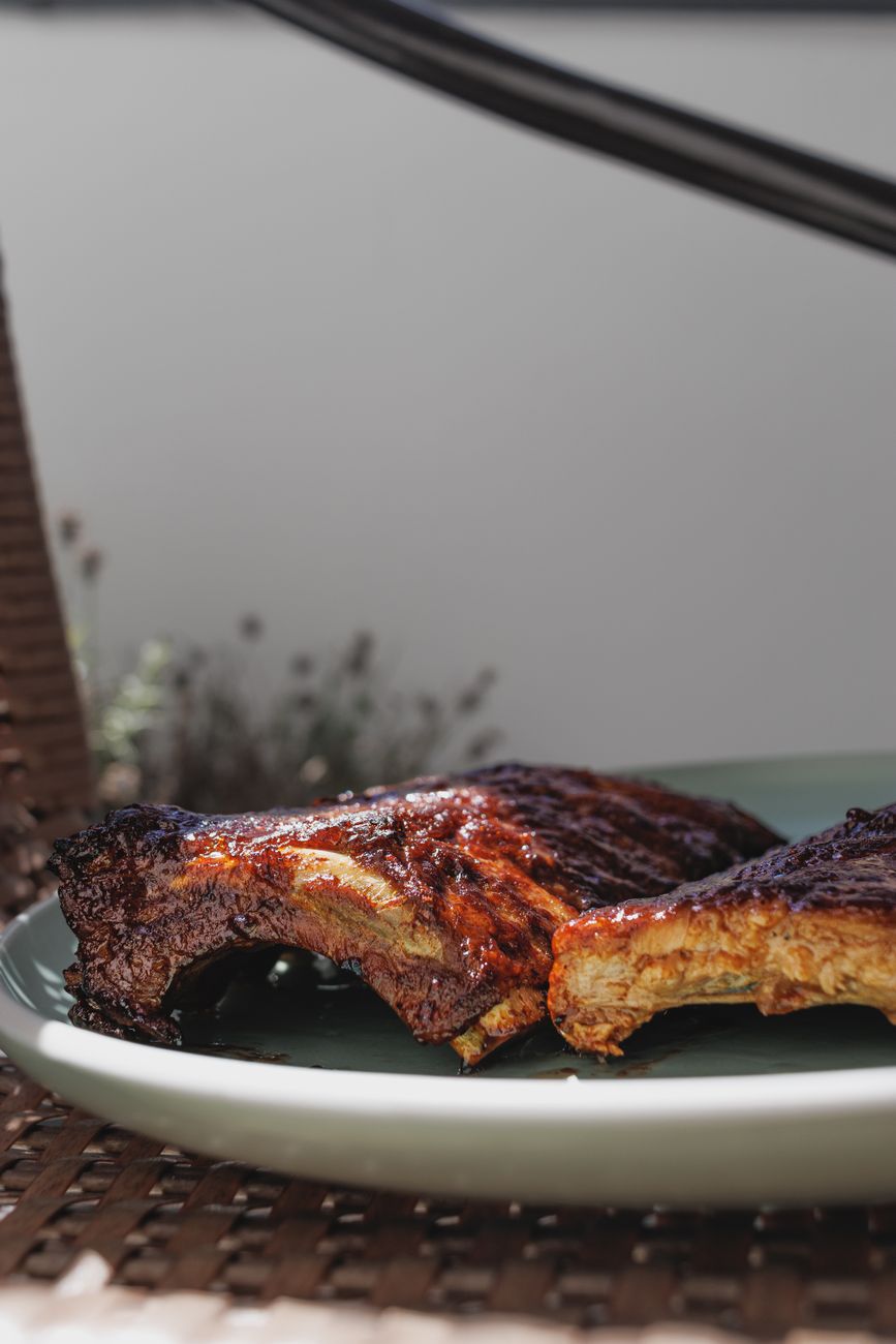 A plate of grilled barbecue ribs served outdoors