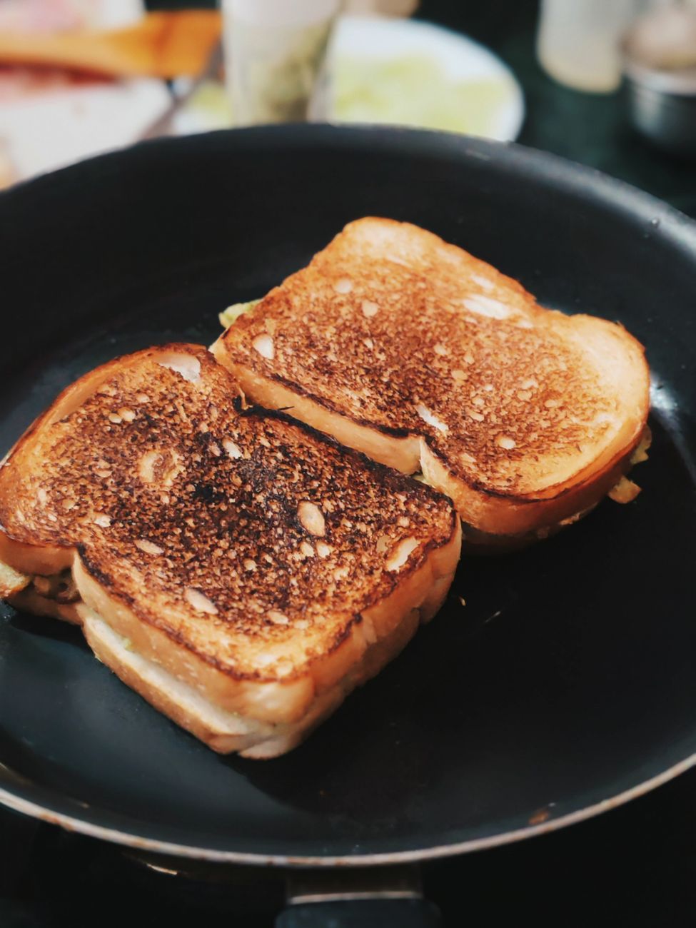 Delicious grilled cheese sandwiches sizzling in a non-stick pan