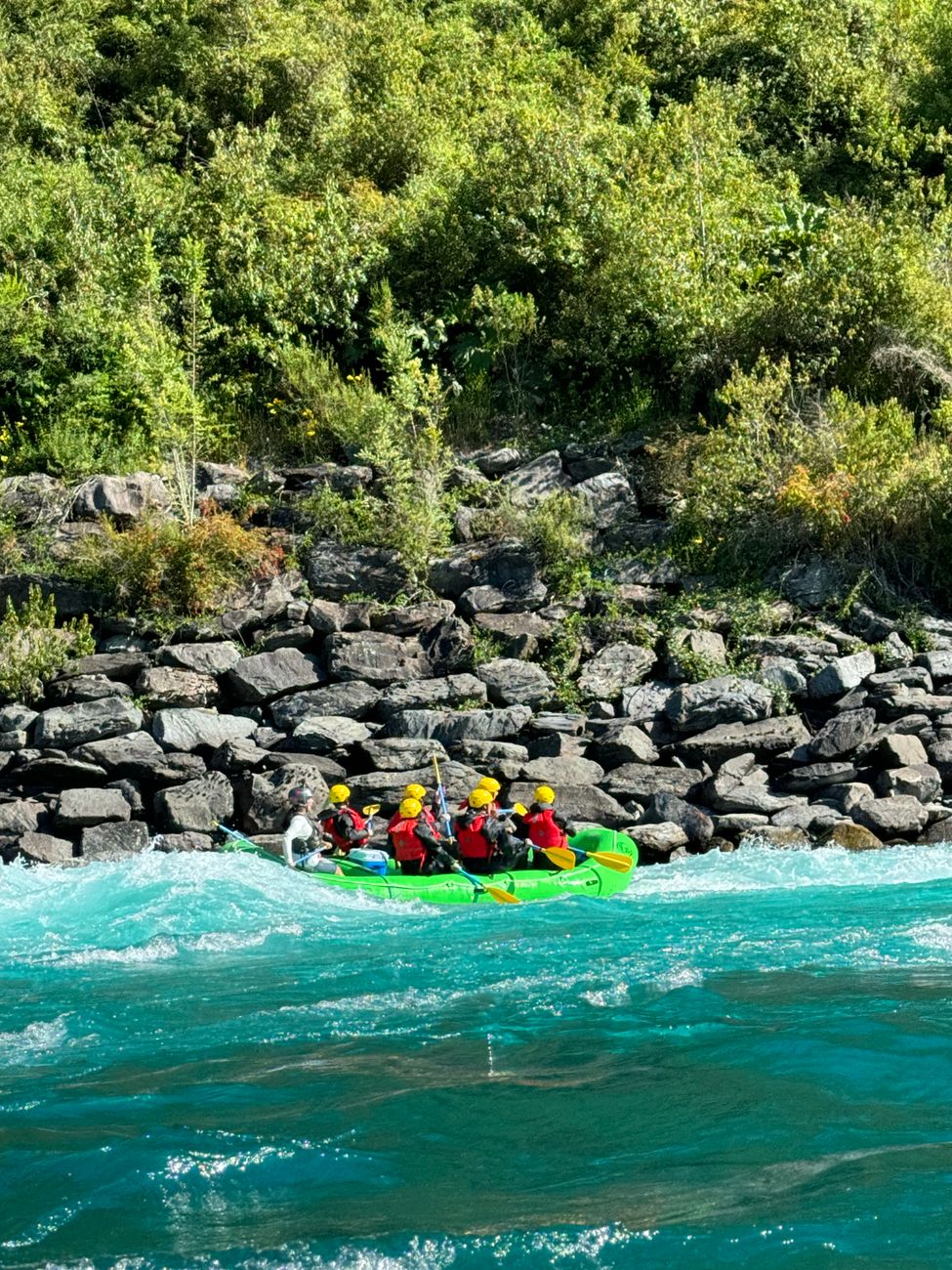 A group of people enjoying an exciting rafting adventure on a river
