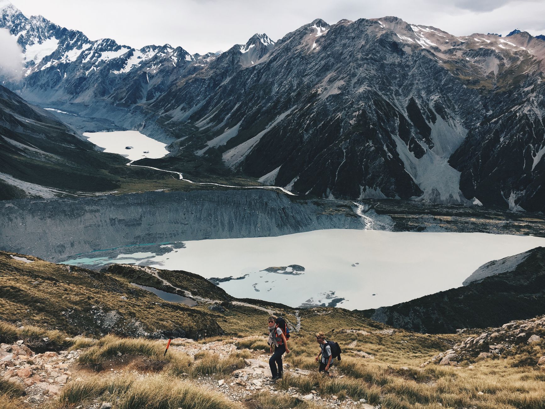 Hikers exploring a rugged mountain landscape with stunning alpine views