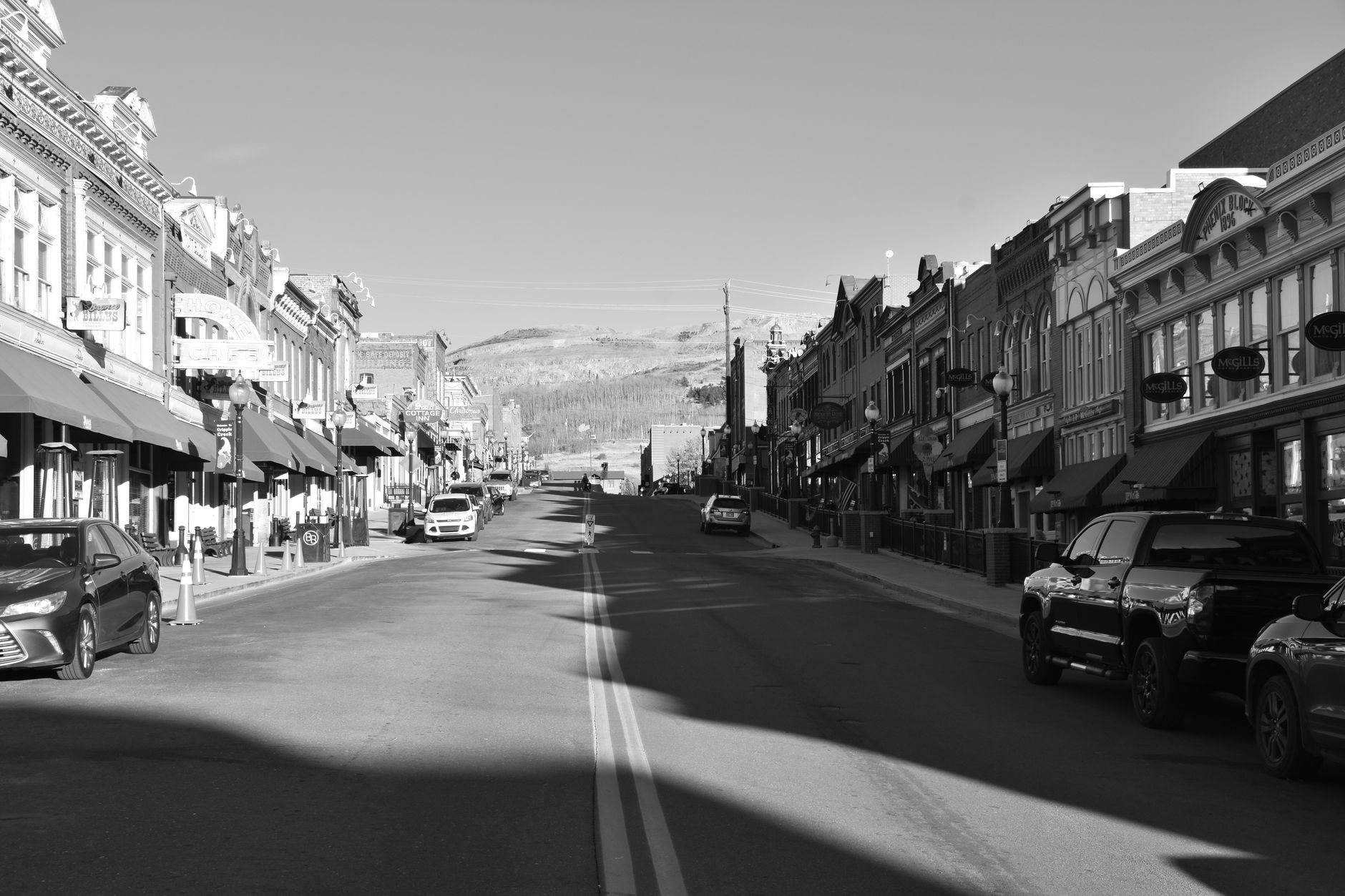 Black and white photo of a historic main street with vintage buildings