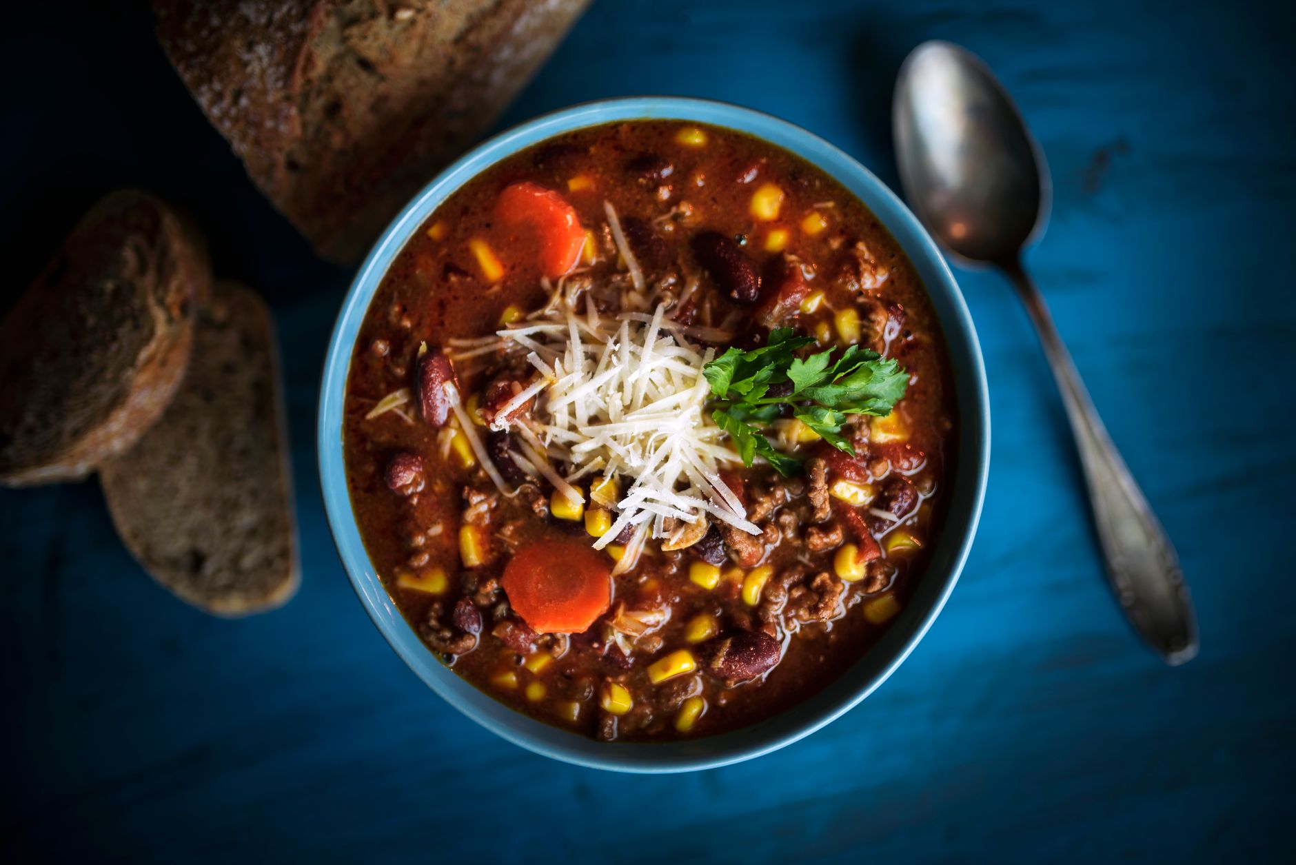 Delicious homemade beef chili served with fresh bread on a rustic table