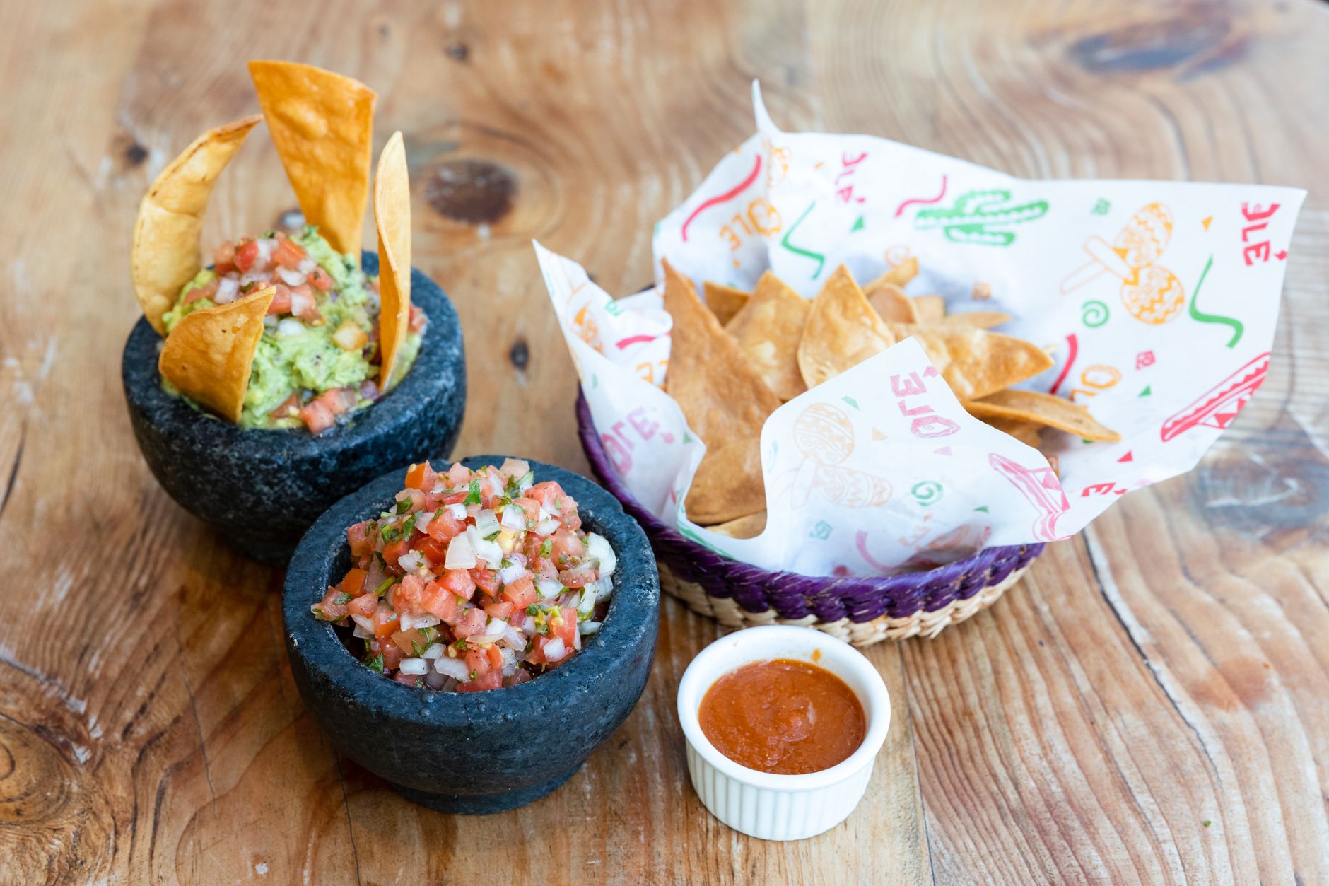 Delicious homemade Mexican salsa and guacamole with crispy tortilla chips