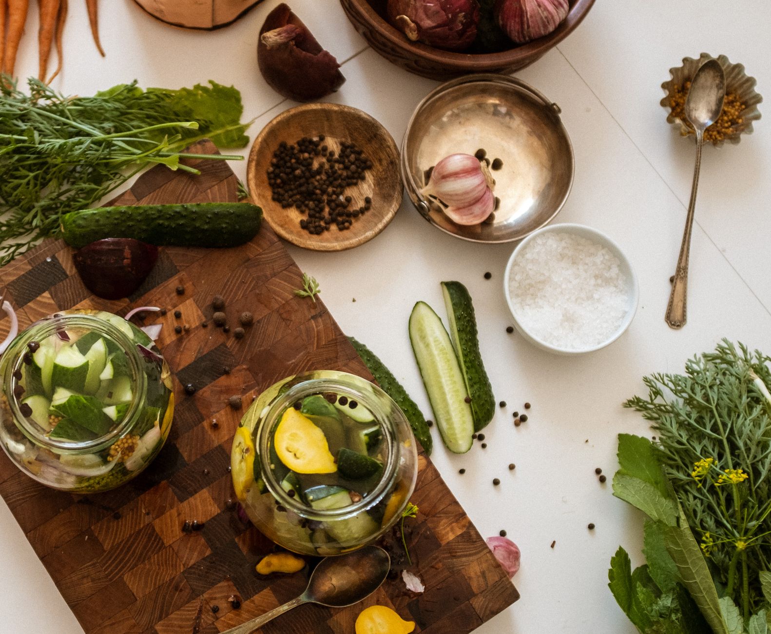 Aerial view of kitchen table with fresh vegetables and pickle preparation