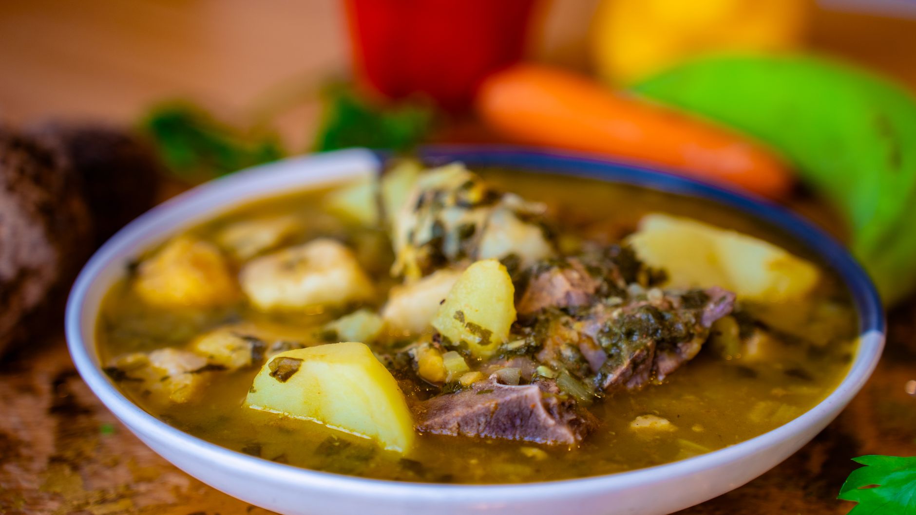 A Mexican-style beef stew with potatoes and herbs in a bowl