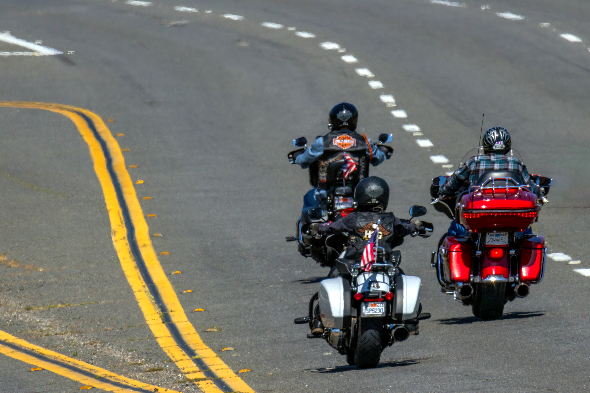 Three motorcyclists riding freely on a highway