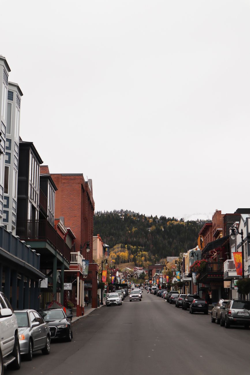 Scenic street in a mountain town with autumn foliage and historic buildings