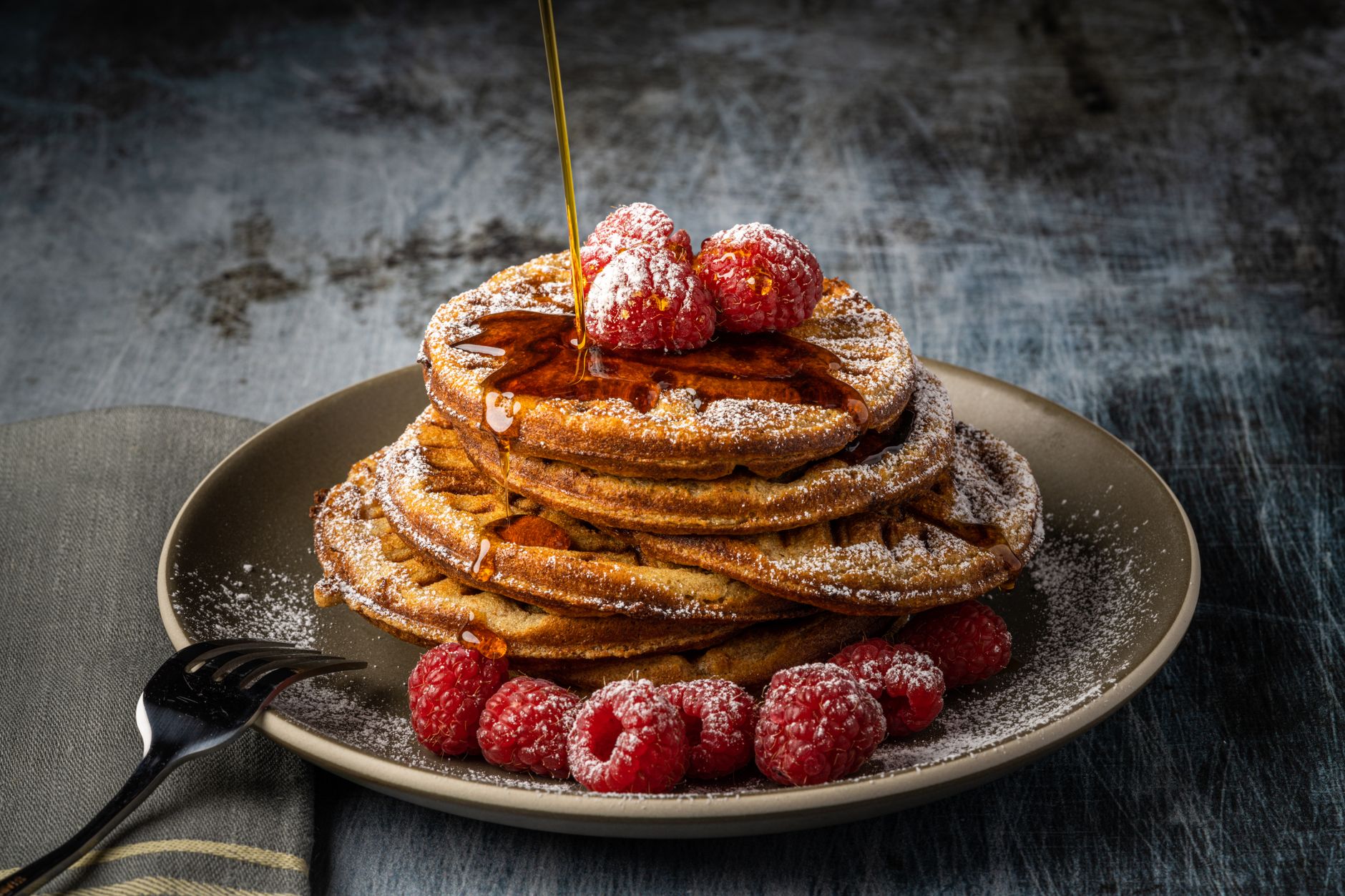 A stack of pancakes topped with maple syrup