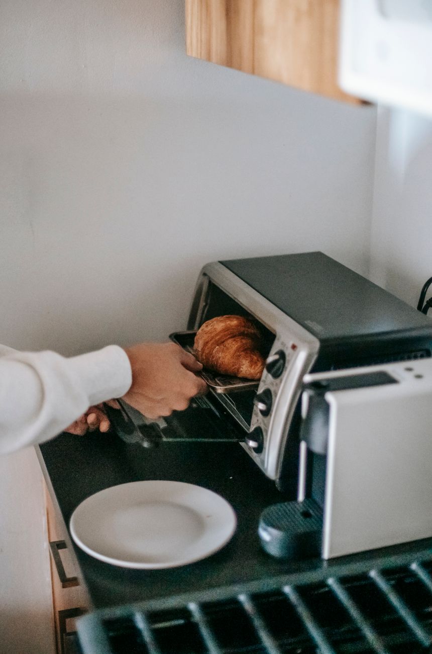 From above of a person using a microwave oven while heating food