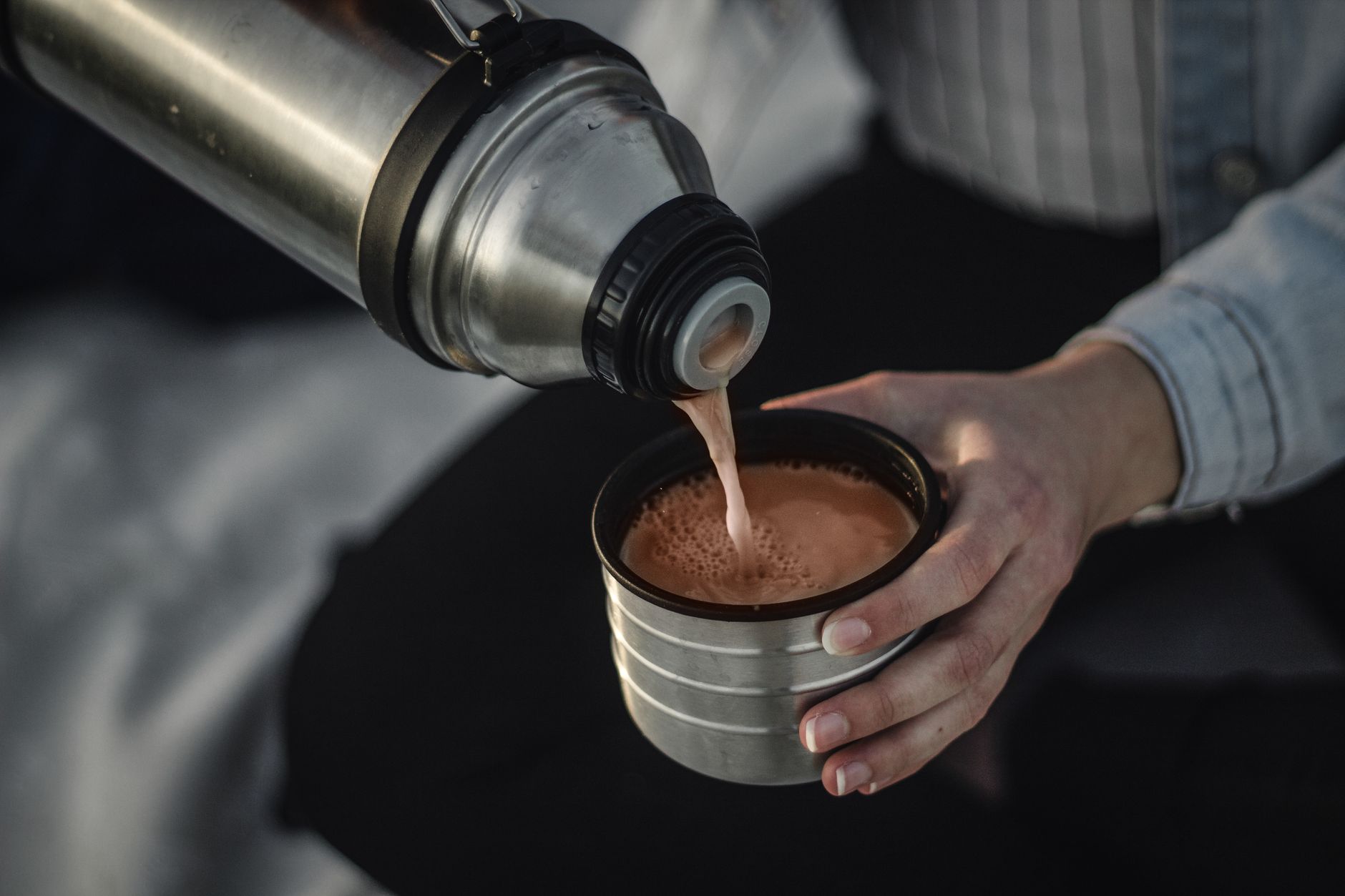 From above of a person pouring aromatic hot coffee