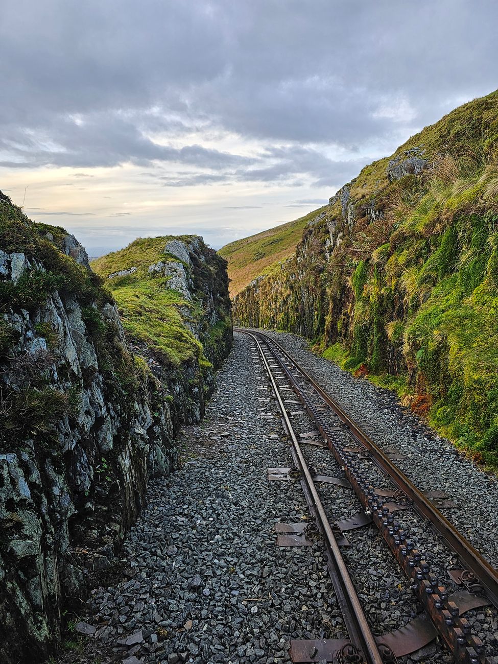 A picturesque railway track winding through rugged rocky hillsides