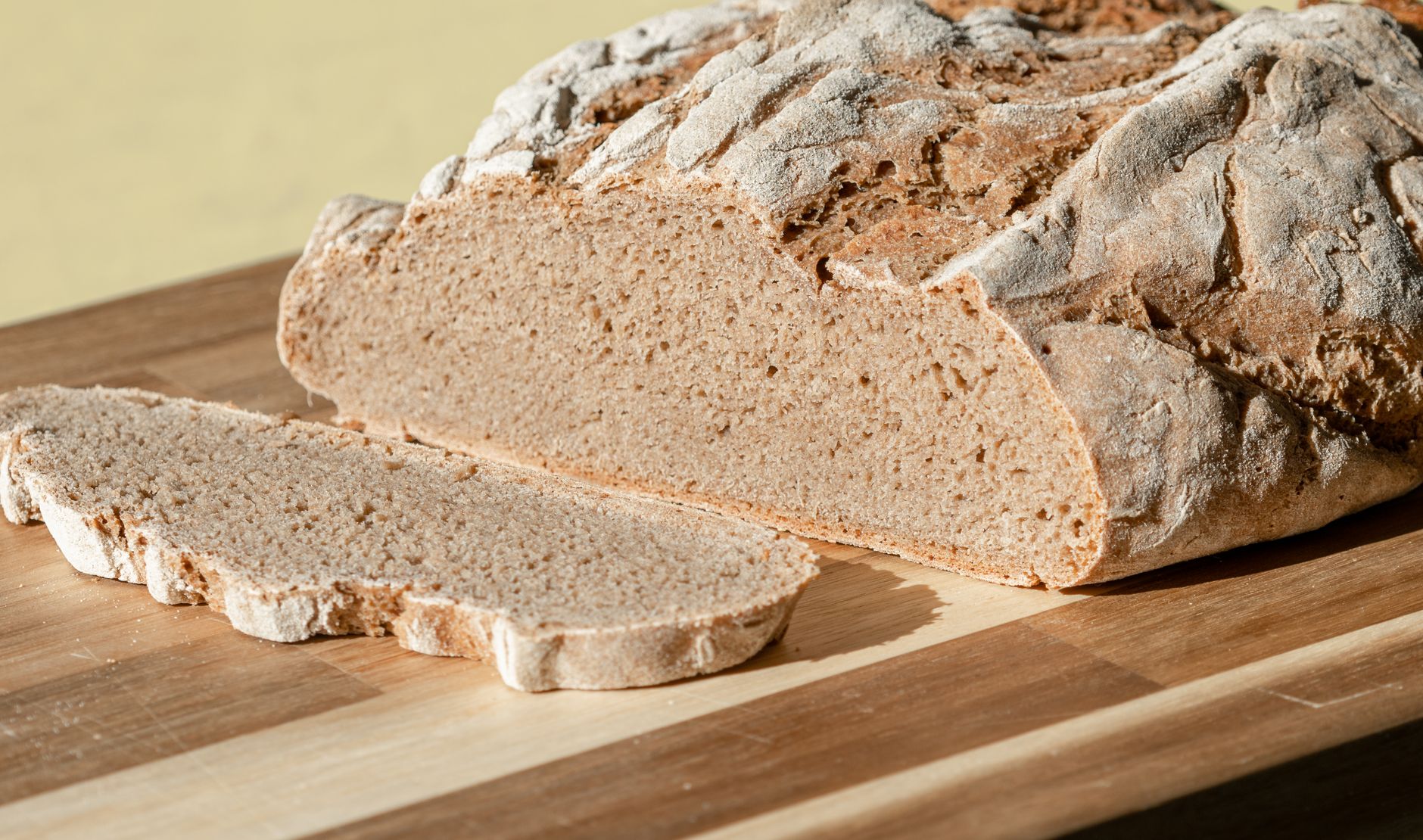 Close-up of freshly baked rustic rye bread on a wooden chopping board