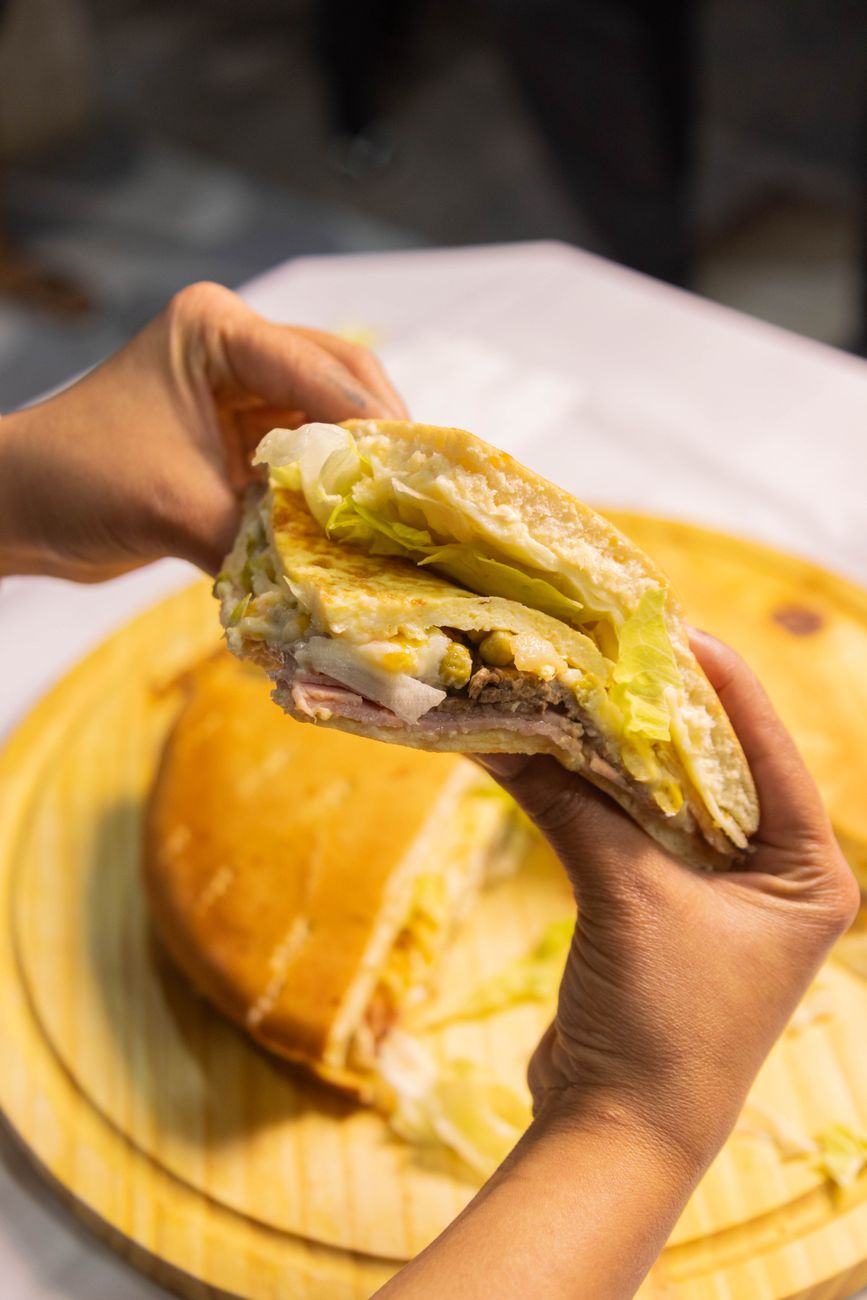 A delicious sandwich filled with lettuce and savory meat