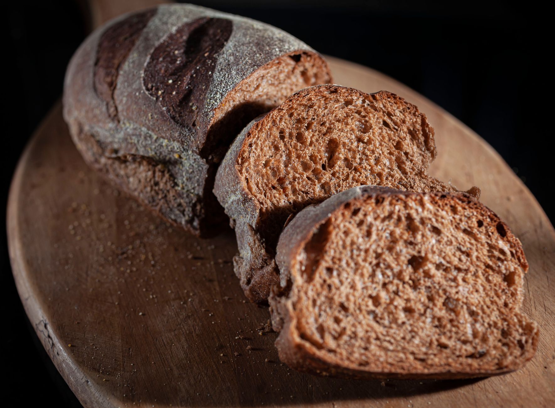 Close-up of sliced artisan bread on a rustic wooden board