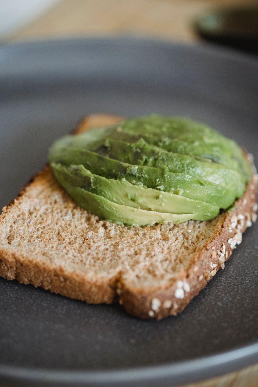 A detailed shot of sliced avocado on wholegrain toast