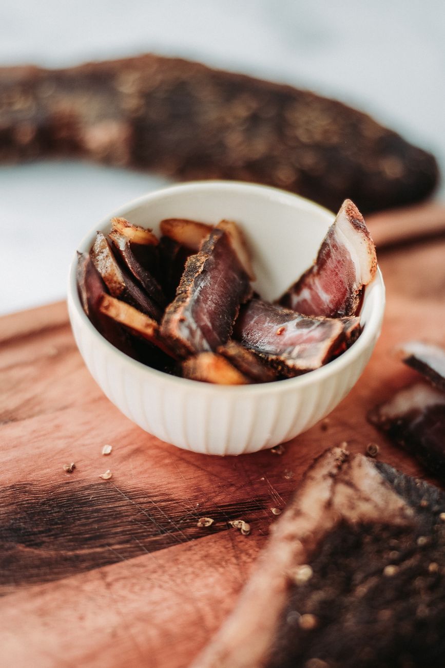 A close-up of sliced cured meat served in a bowl