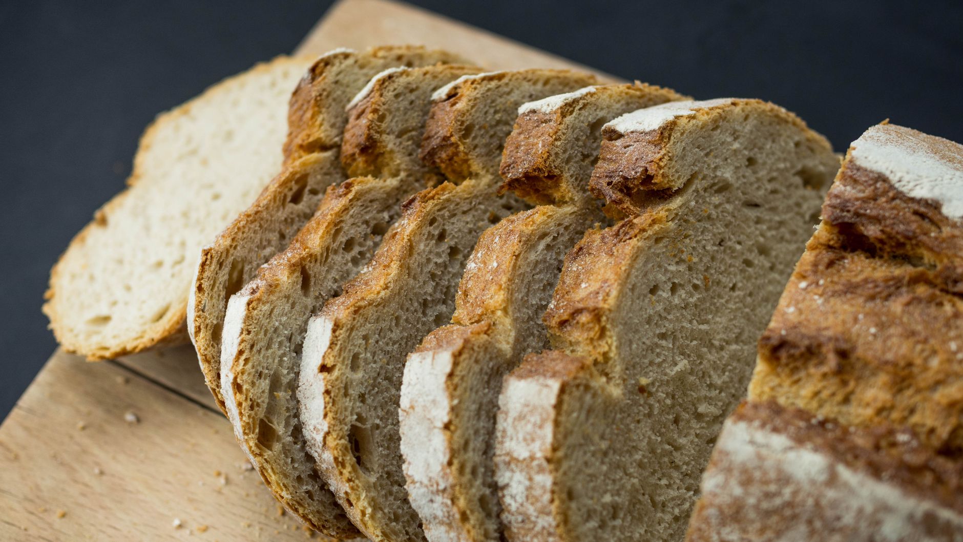 Close-up of freshly sliced healthy wheat bread on a wooden board