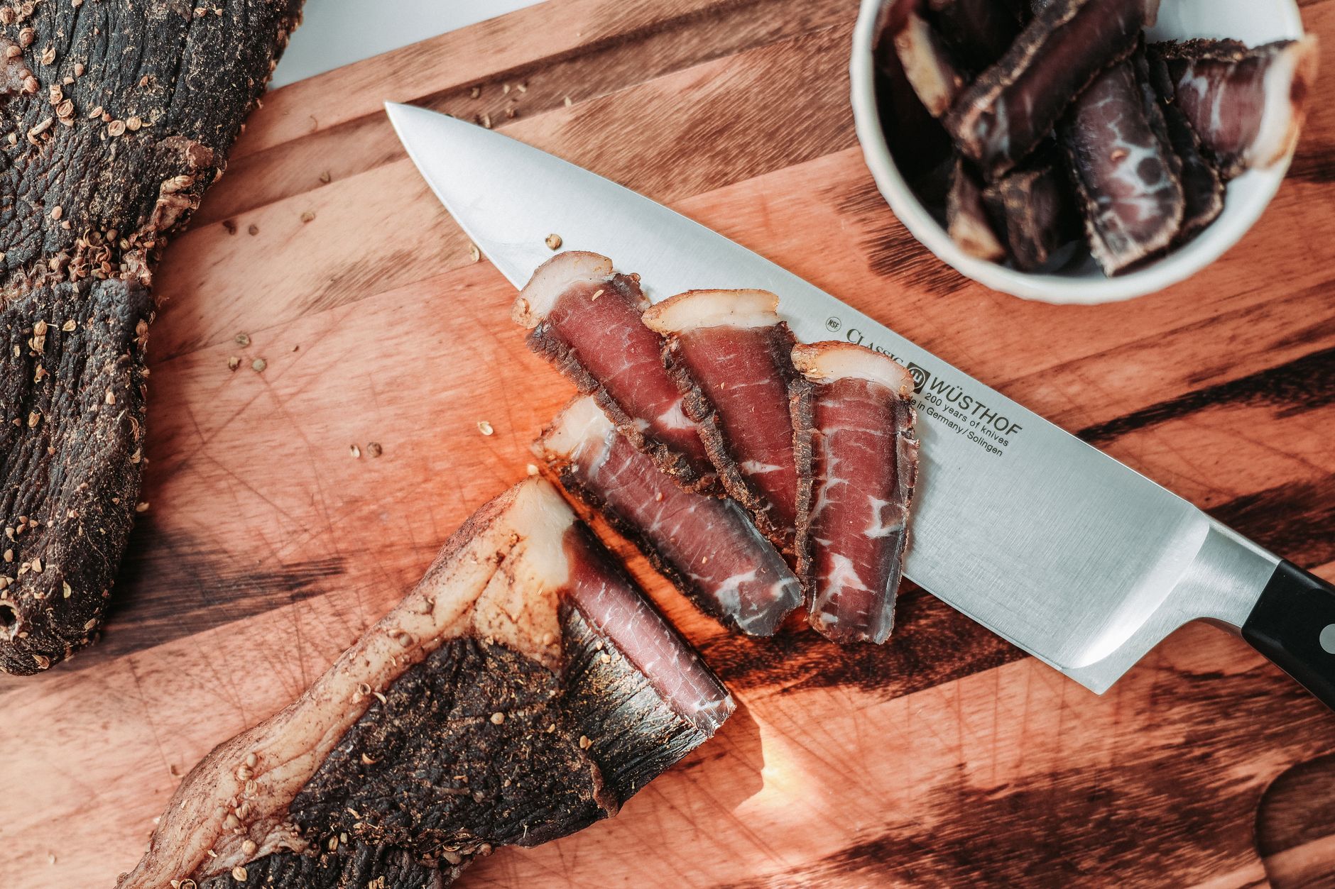 A close-up view of thinly sliced cured meat
