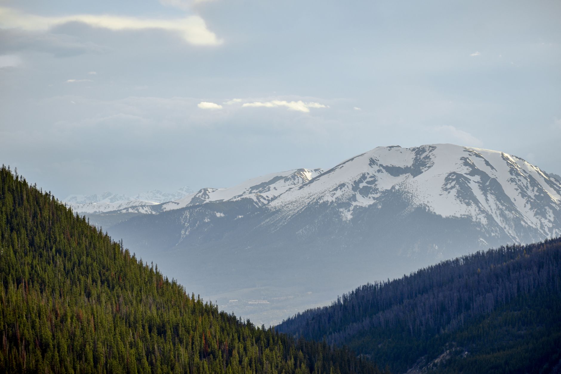 Snow-capped Rocky Mountains and lush conifer forests