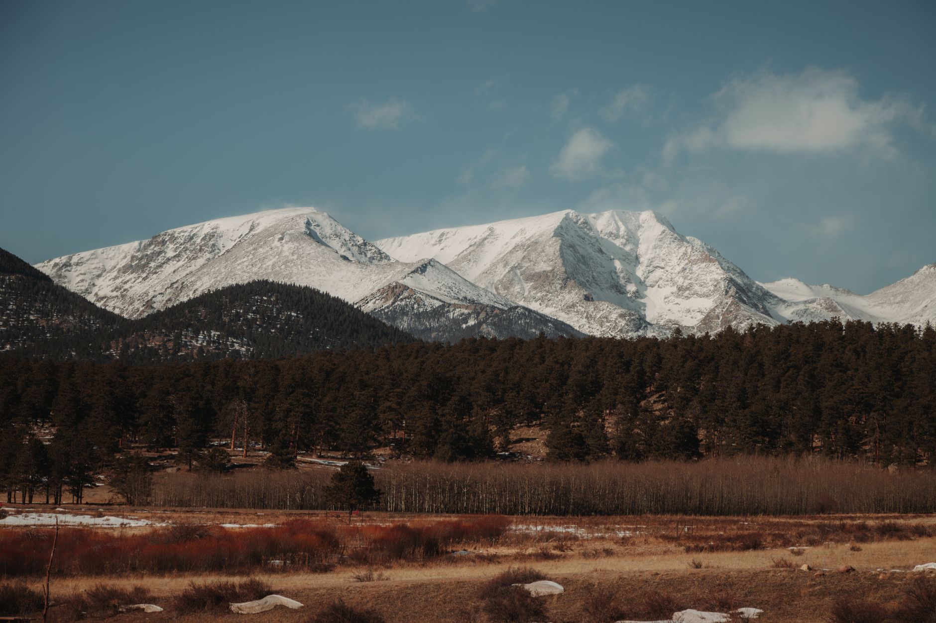 Snow-covered Rocky Mountains with evergreen forest in winter