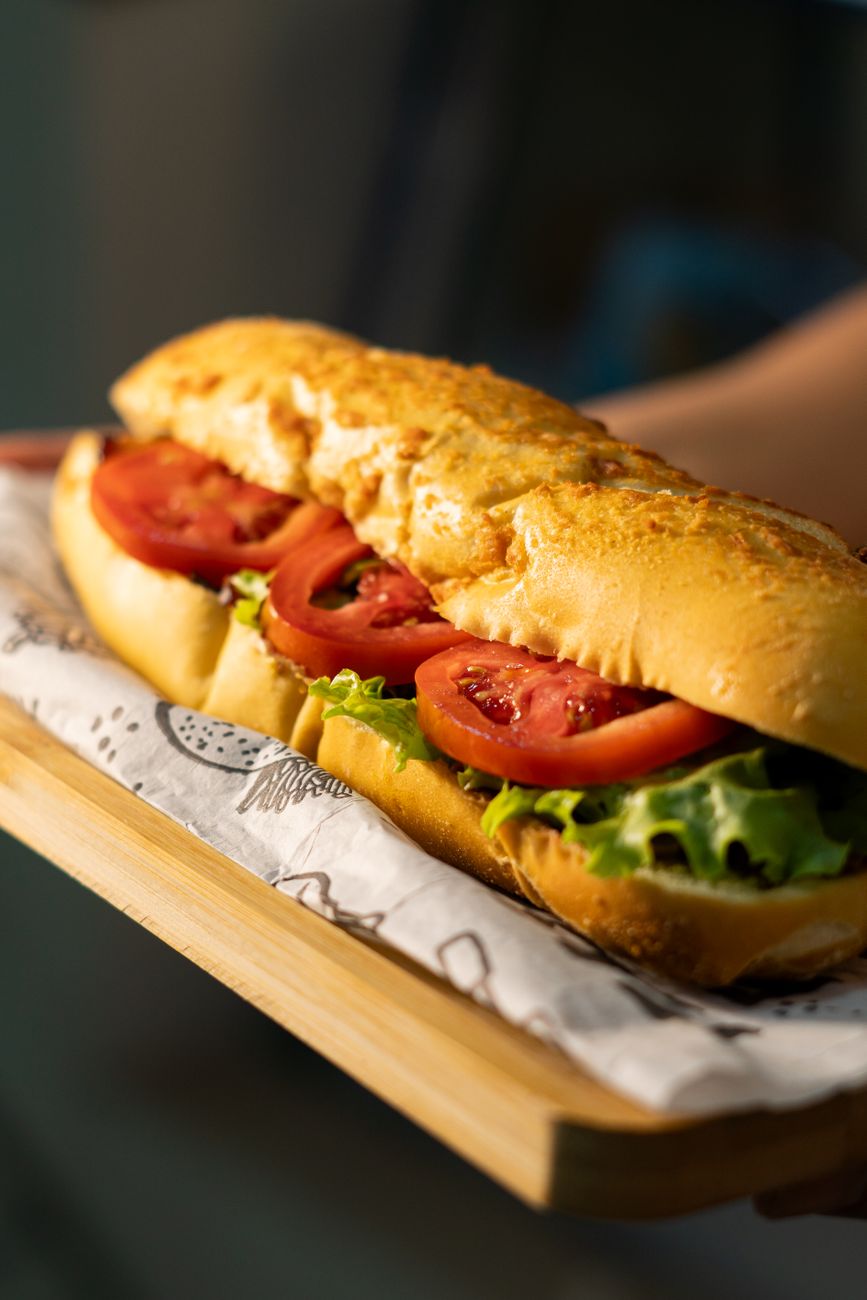Close-up of a sub sandwich with tomato, lettuce, and cheese