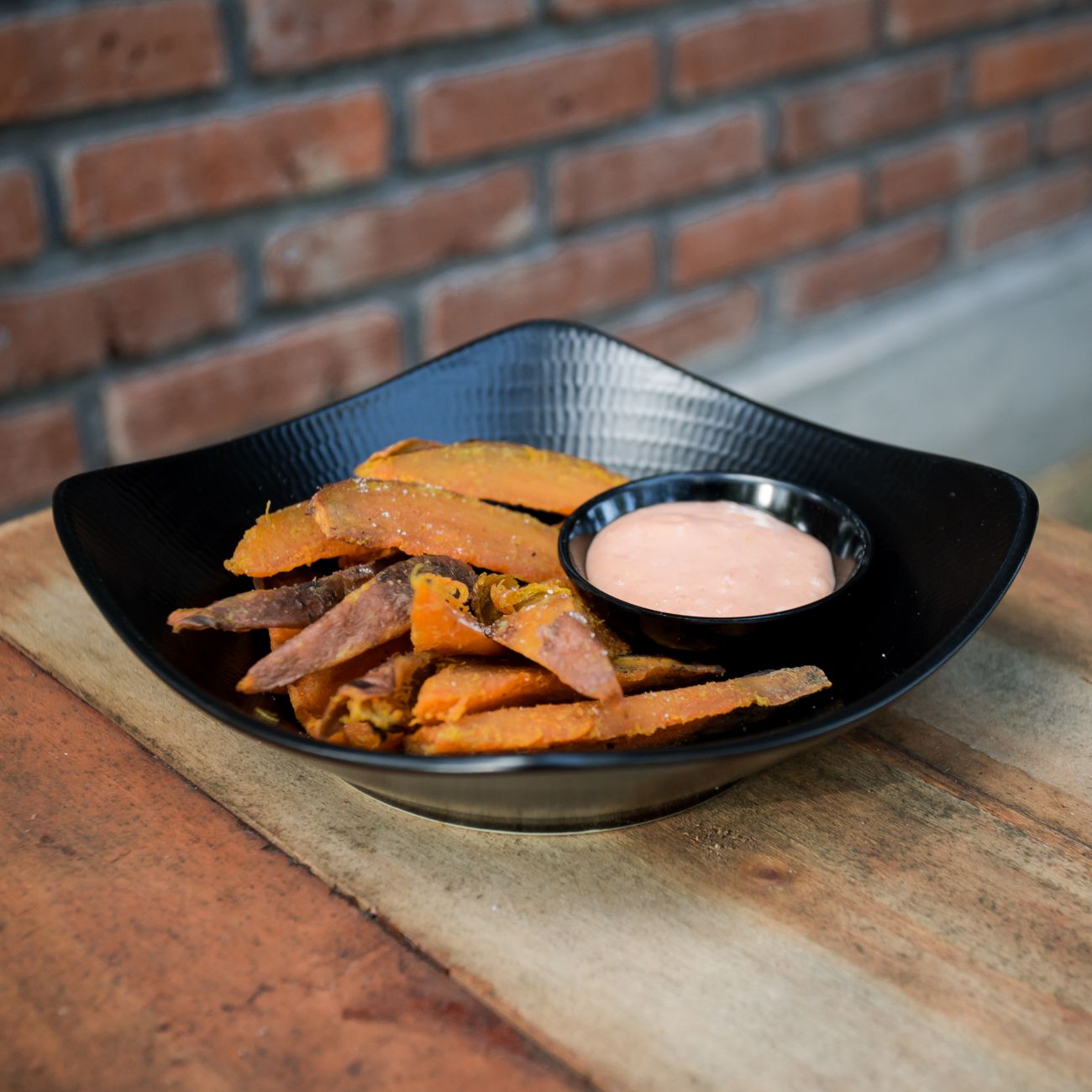 Sweet potato fries served alongside a variety of dipping sauces
