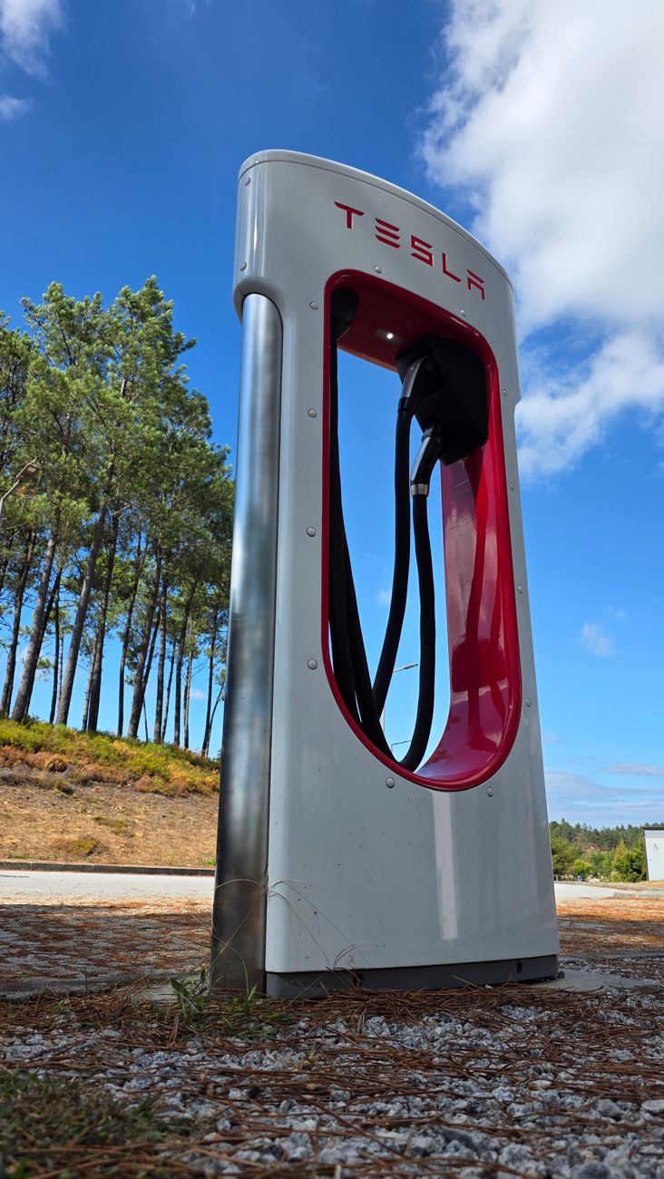 Tesla Supercharger charging stall with connector, photographed roadside
