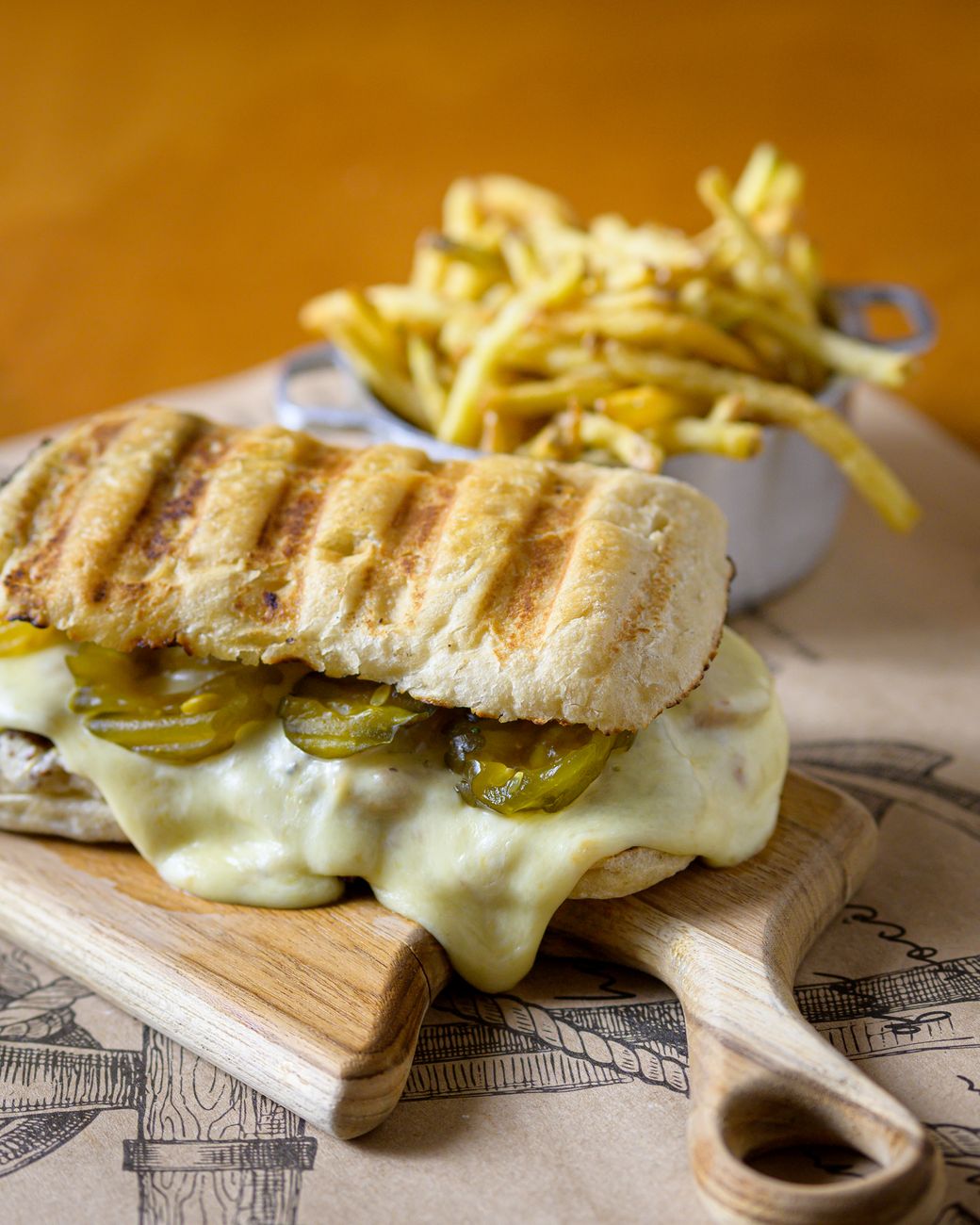 A toasted sandwich filled with cucumber and melted cheese